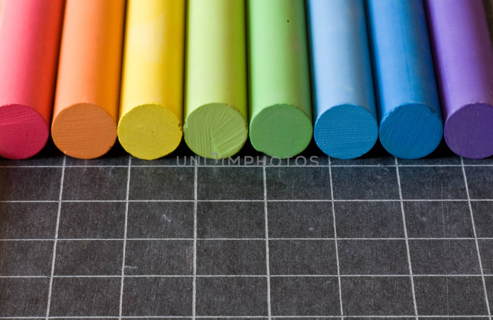 school supplies - chalks on chalkbord closeup