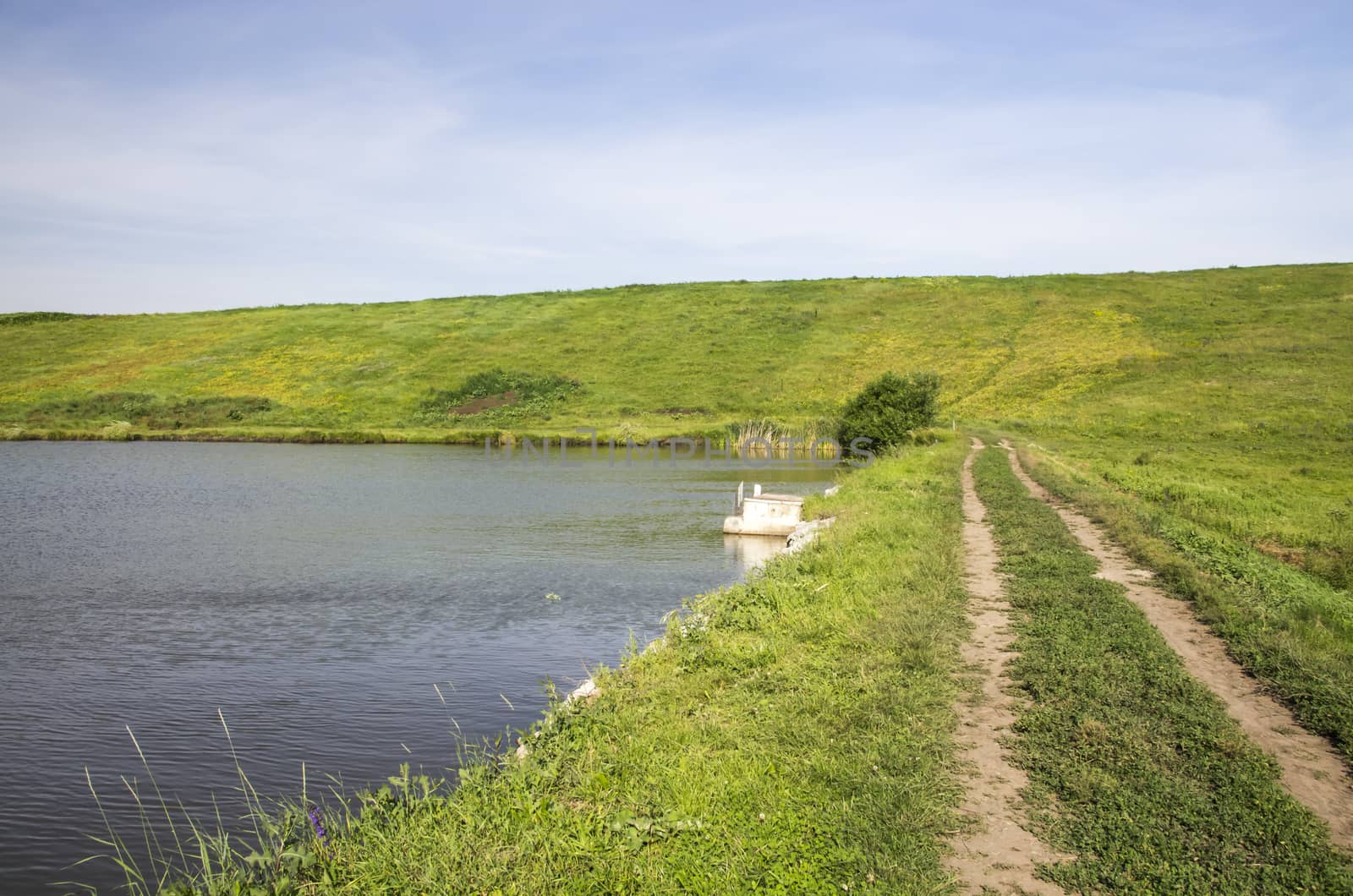 Ground road on a small lake dam