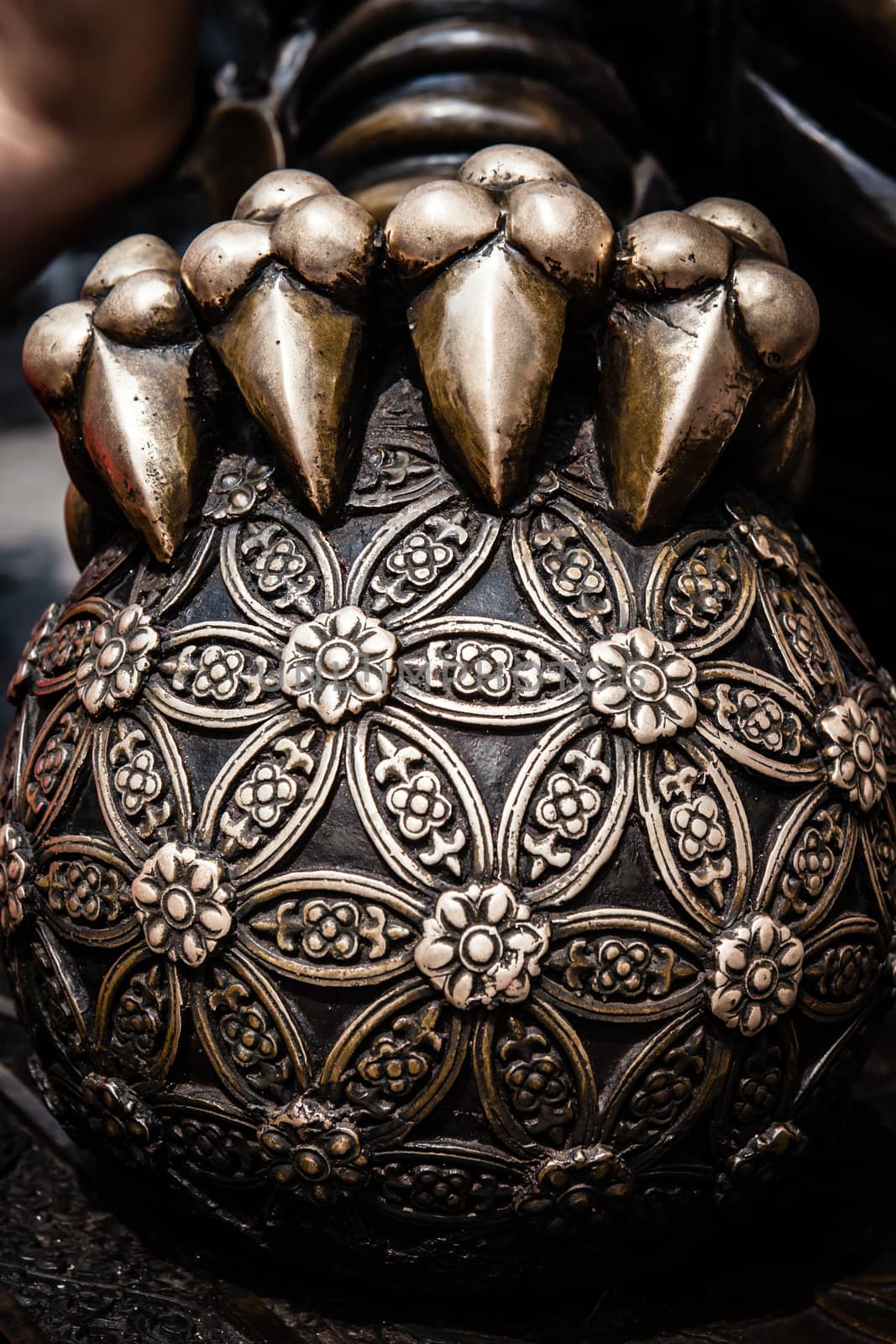 Chinese guardian lion closeup of ball with flower of light pattern