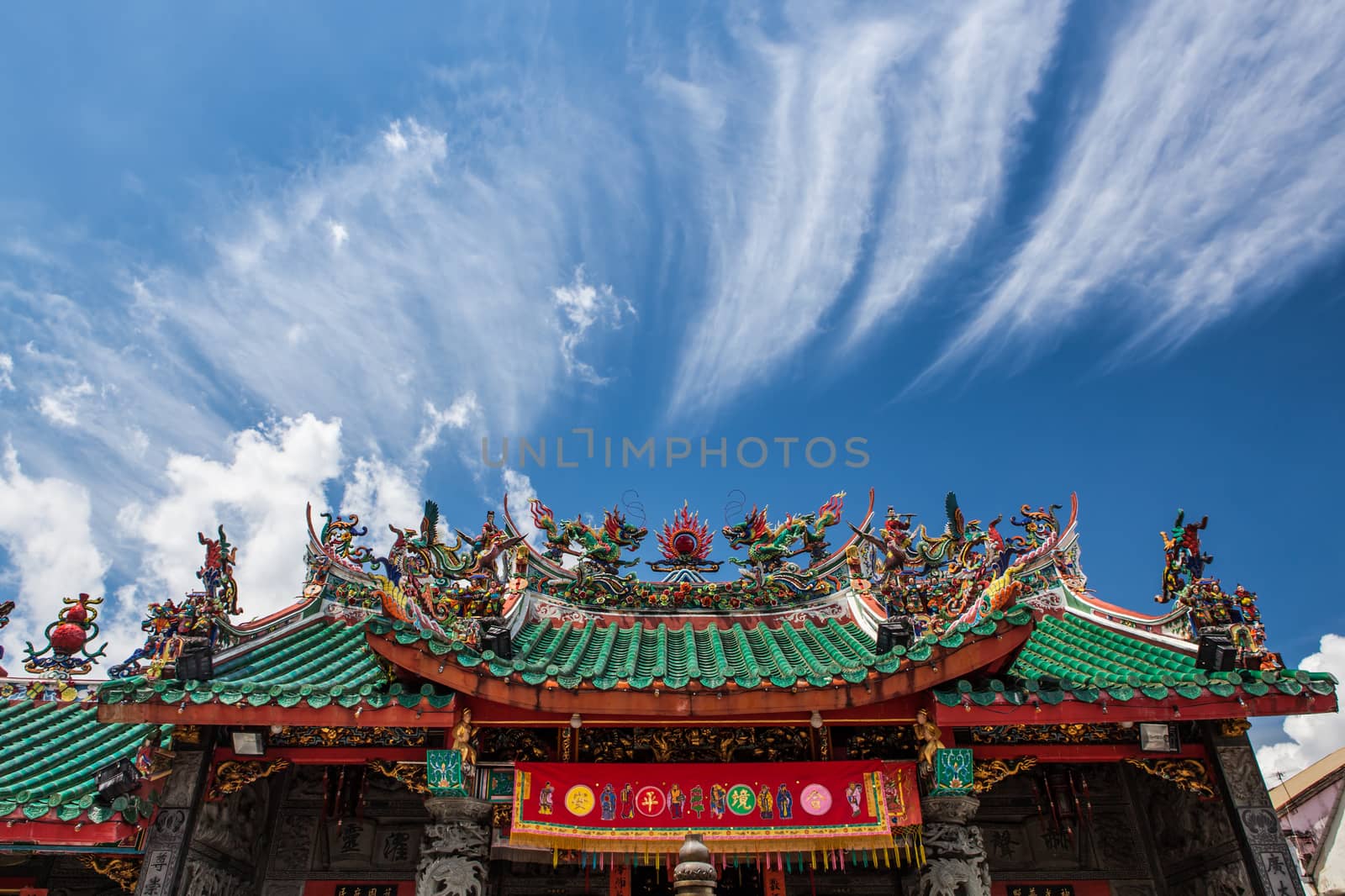 Chinese temple roof and blue sky with clouds