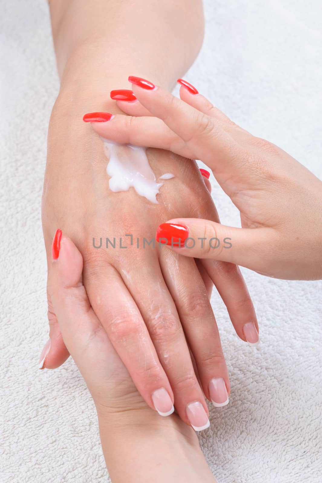 beauty salon, applying moisturizing cream onto the hands and massaging