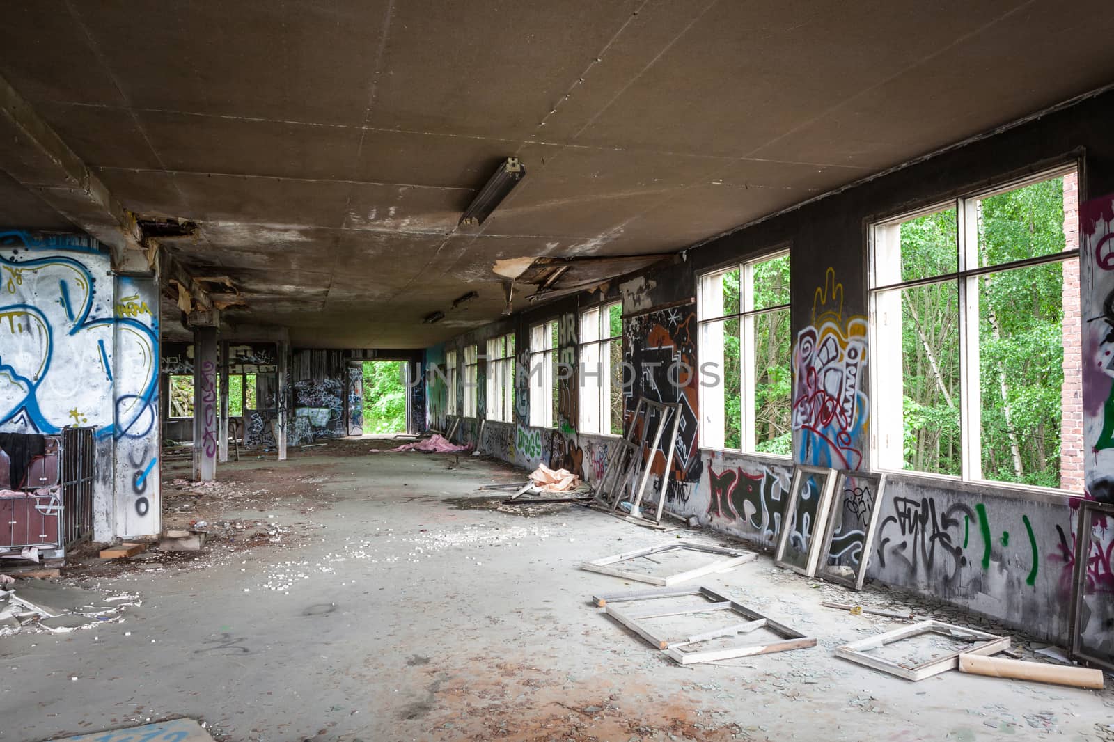 Messy abandoned factory hall and windows