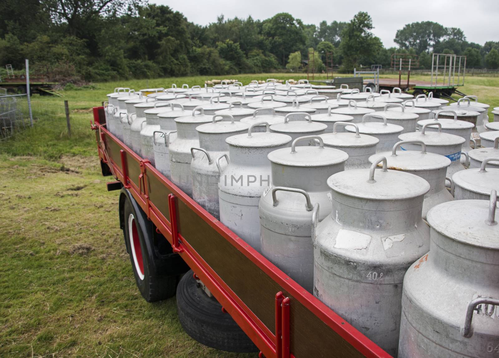 historical car full with zink churn outside 