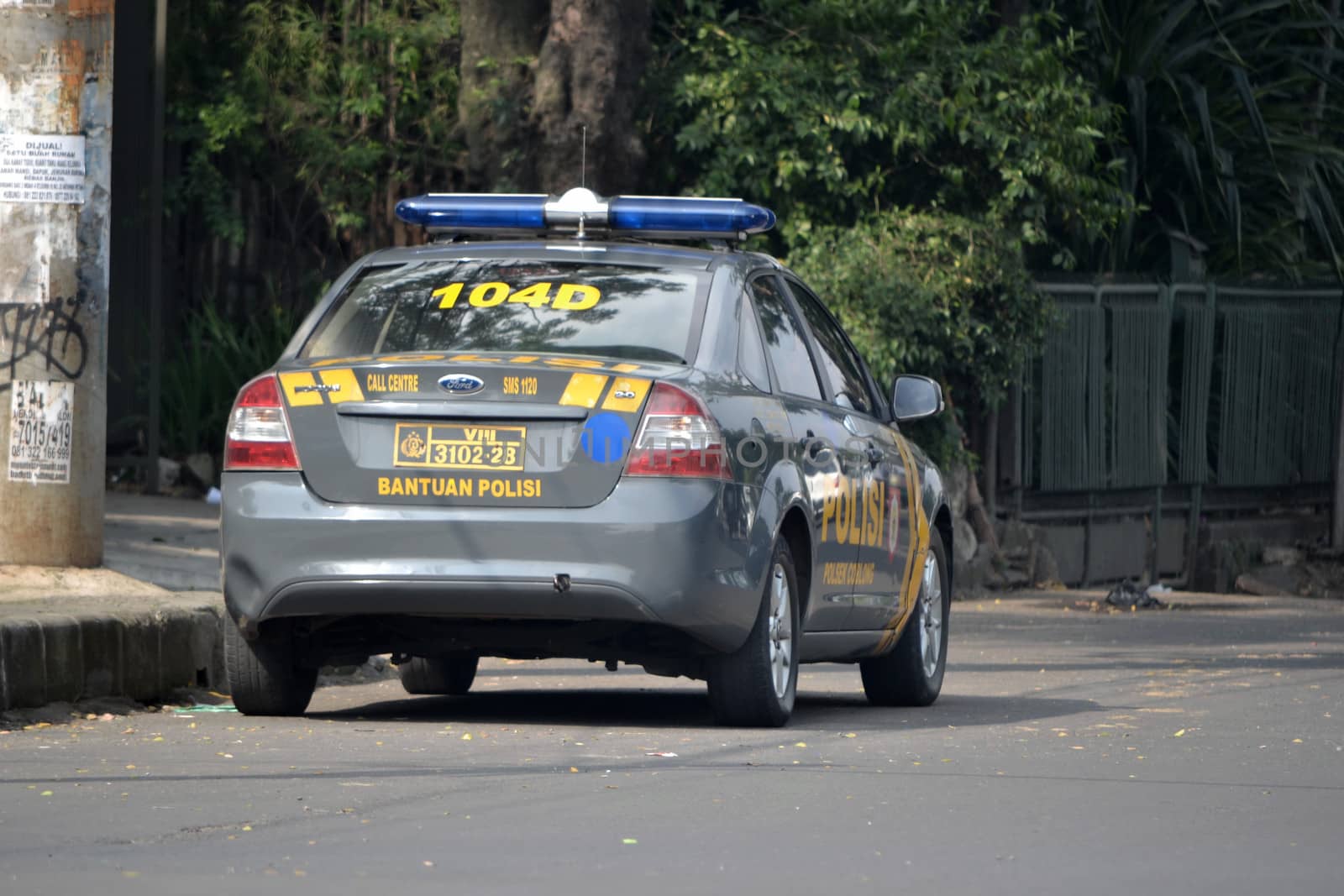 bandung, indonesia-july 3, 2014: indonesian police car parked beside road.