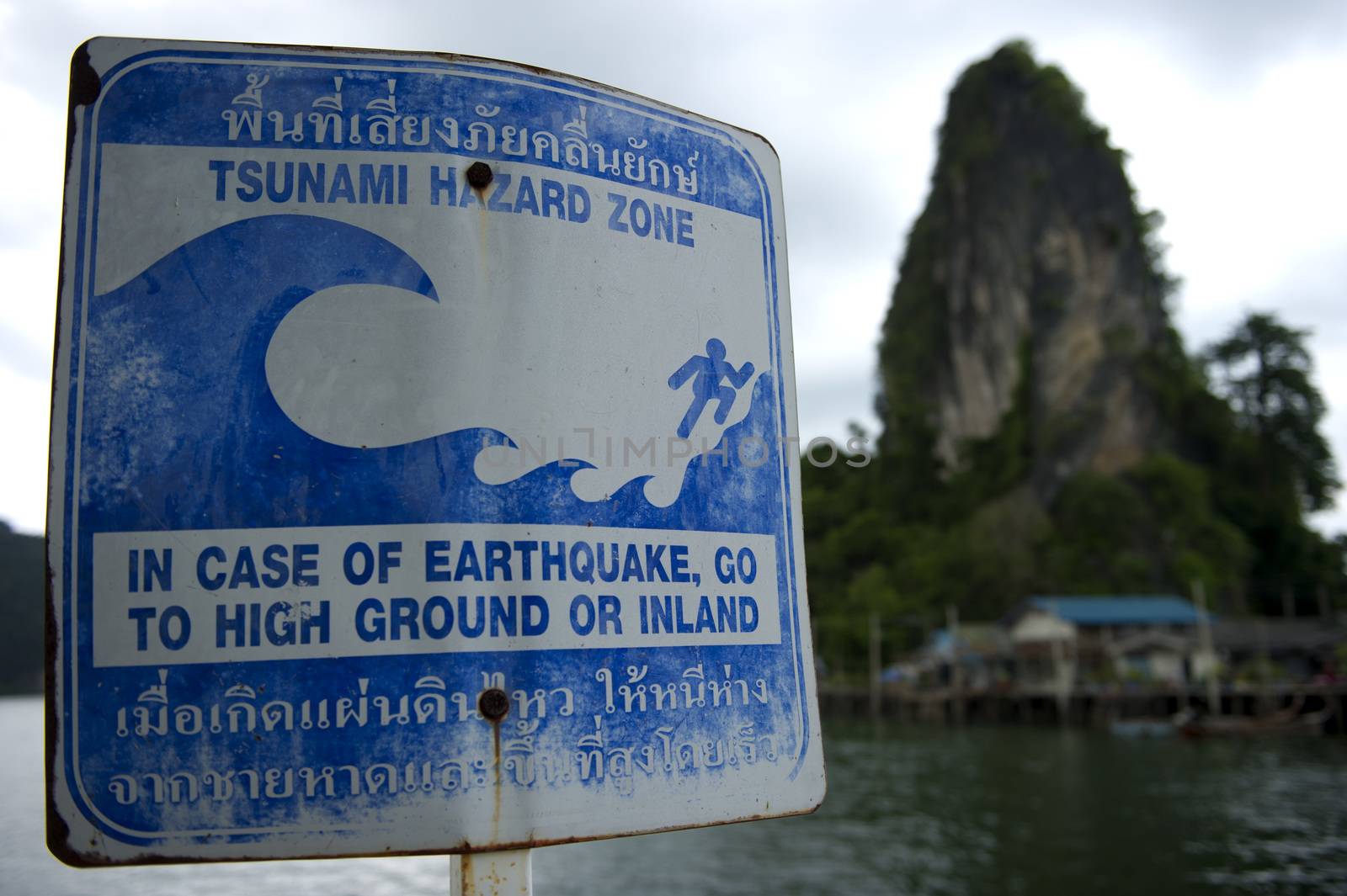 Sign pointing towards the tsunami evacuation route by think4photop