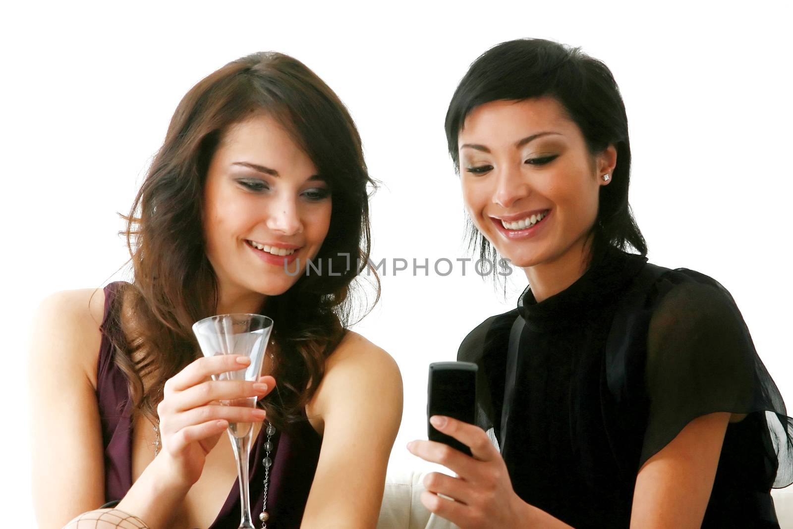 Closeup of cute young girls checking out their new mobilephone at home - Indoor 