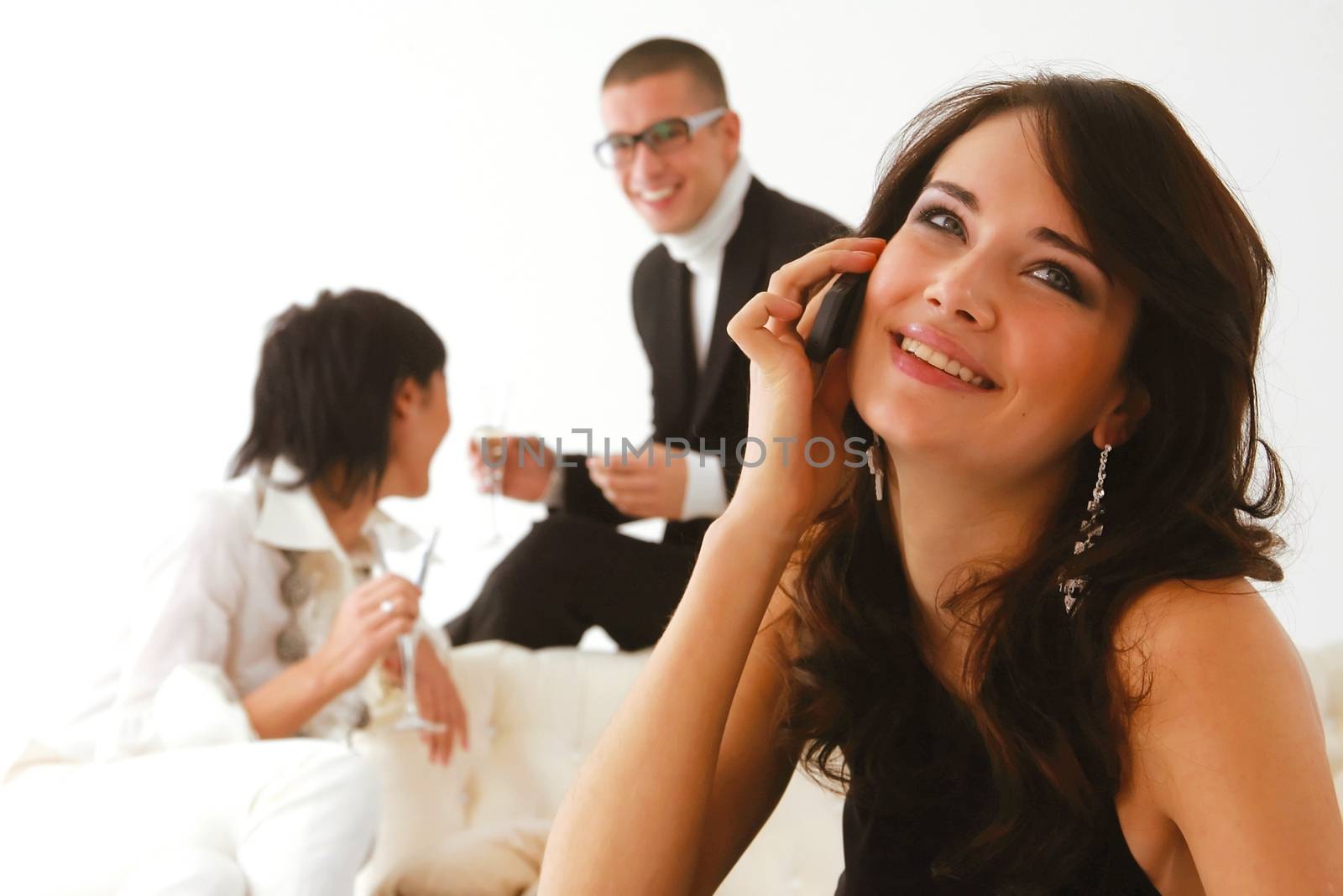 woman speaks on a mobile phone and happy friends