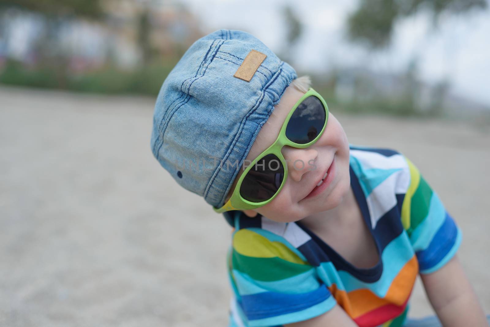 Cute boy in denim hat and sunglasses by anytka