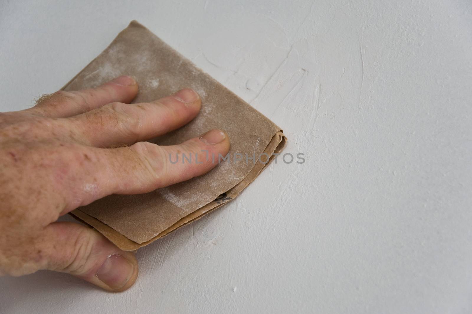 man with sandpaper by NeydtStock