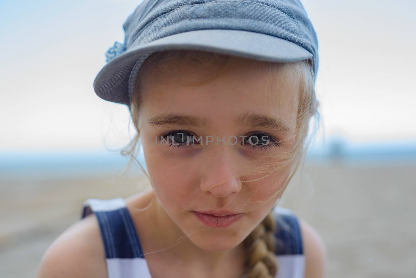 Portrait of little girl who looking with serious face at camera
