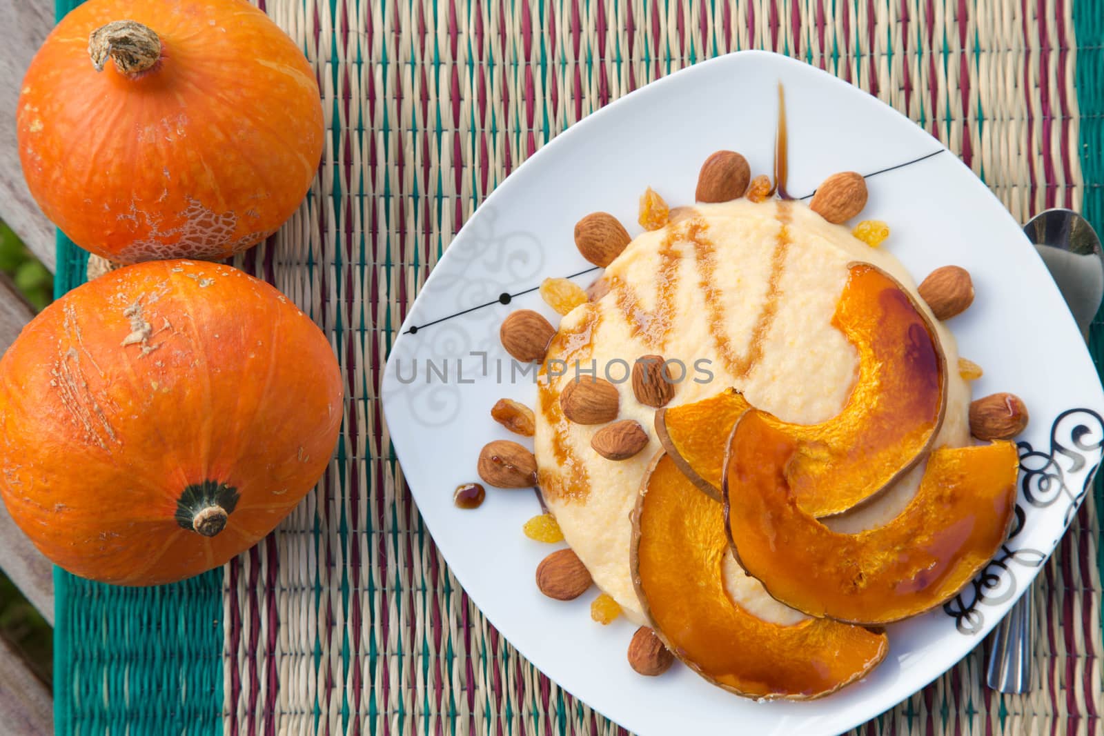 Semolina with baked slices of pumpkin,raisins and almond by tolikoff_photography
