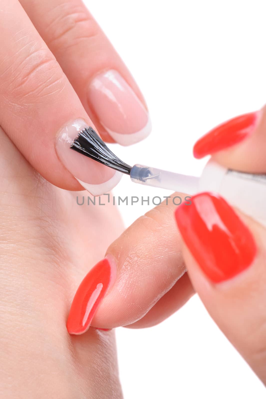 manicure applying, brushing fingernails with clear enamel