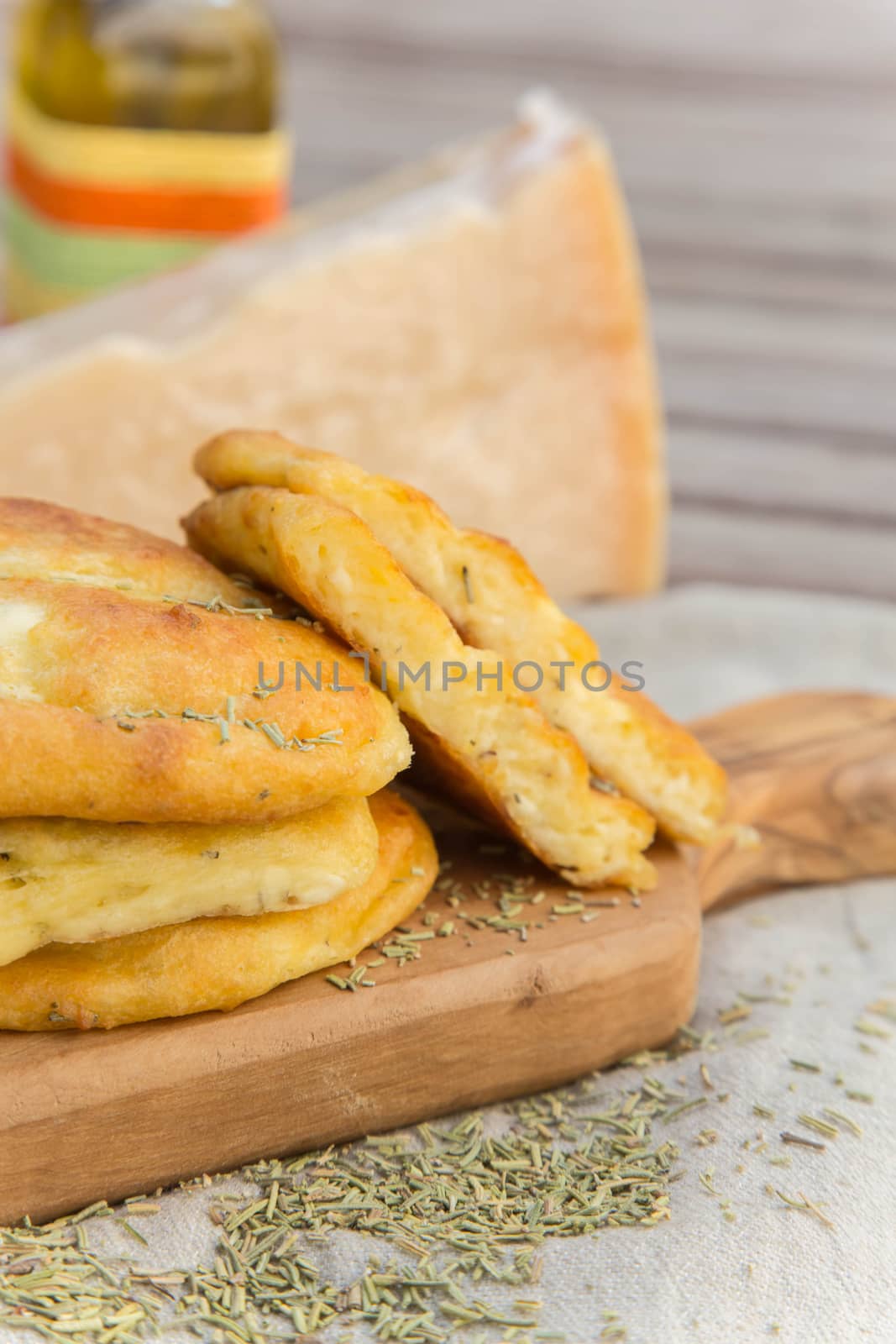 Salty cottage cheese pancakes with dried rosemary on the cutting board