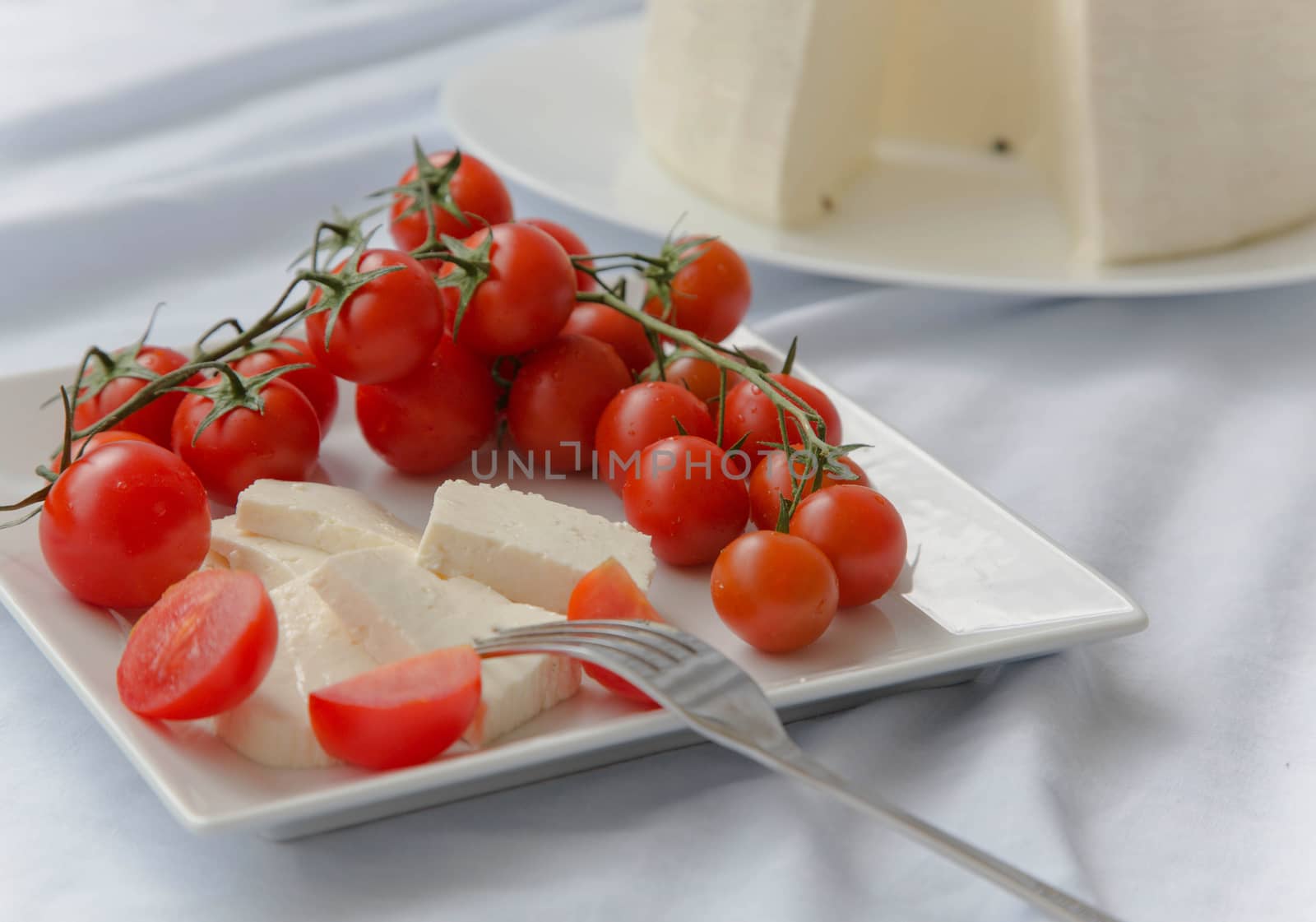 Cherry tomatoes with fresh sicilian cheese by tolikoff_photography