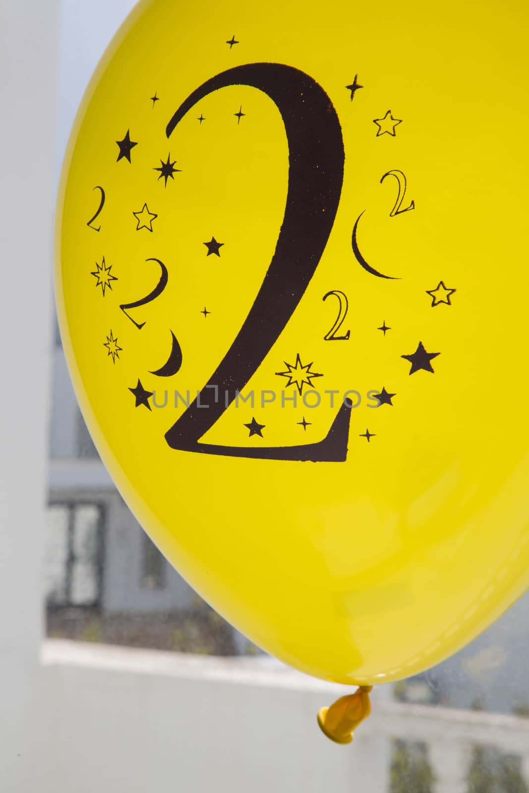 Number two printed in black on the yellow balloon