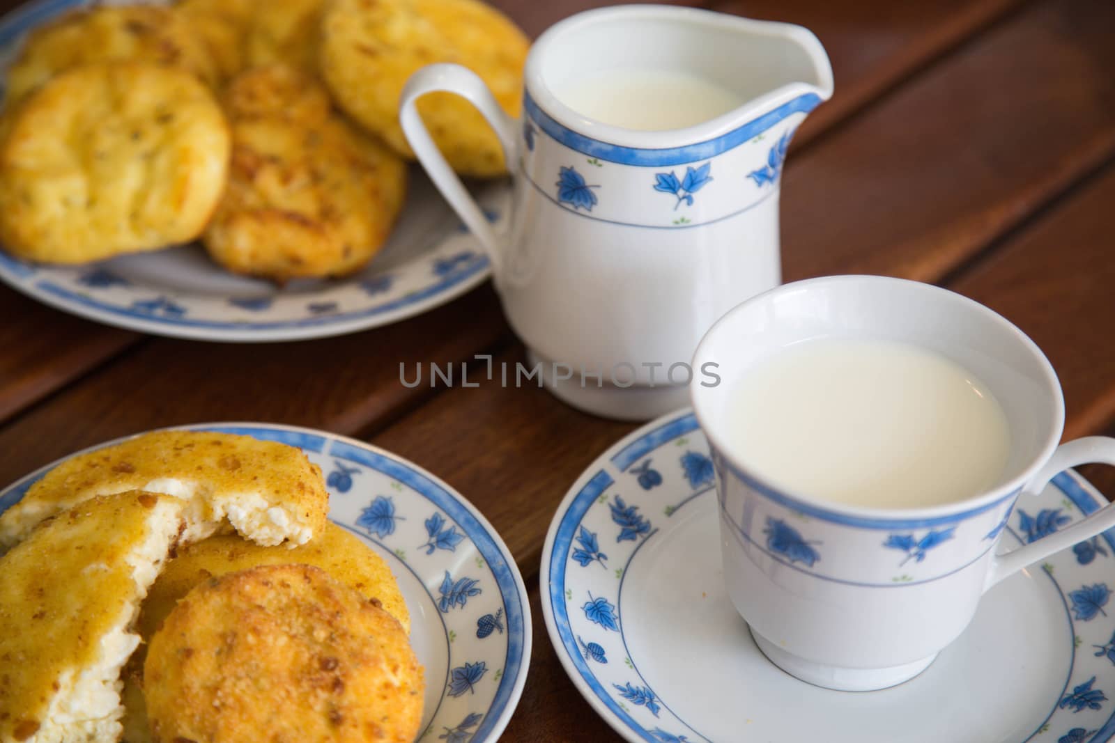 homemade cheese pancake and a cup of warm milk by tolikoff_photography