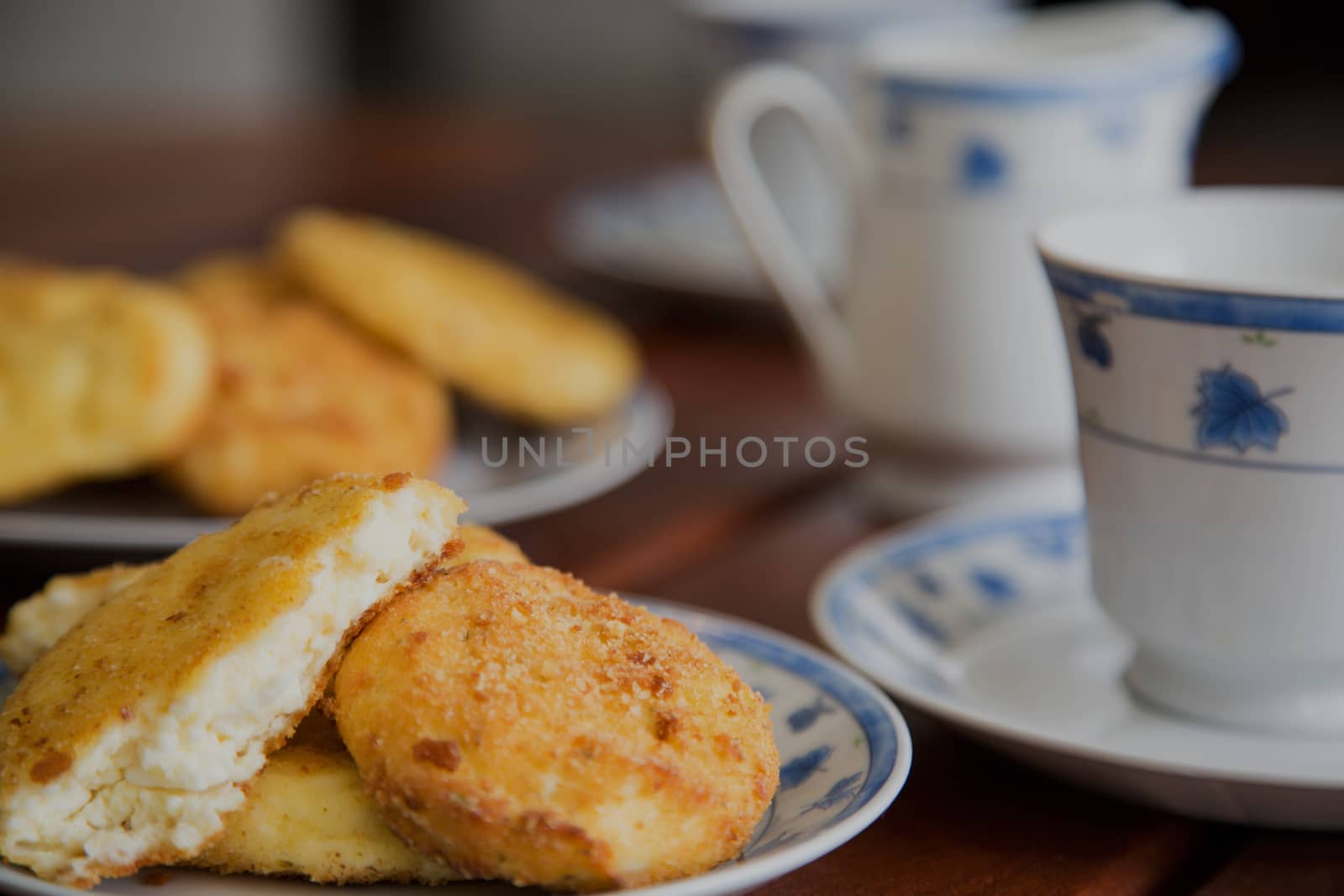 Baked homemade cottage cheese pancakes with a cup of warm milk