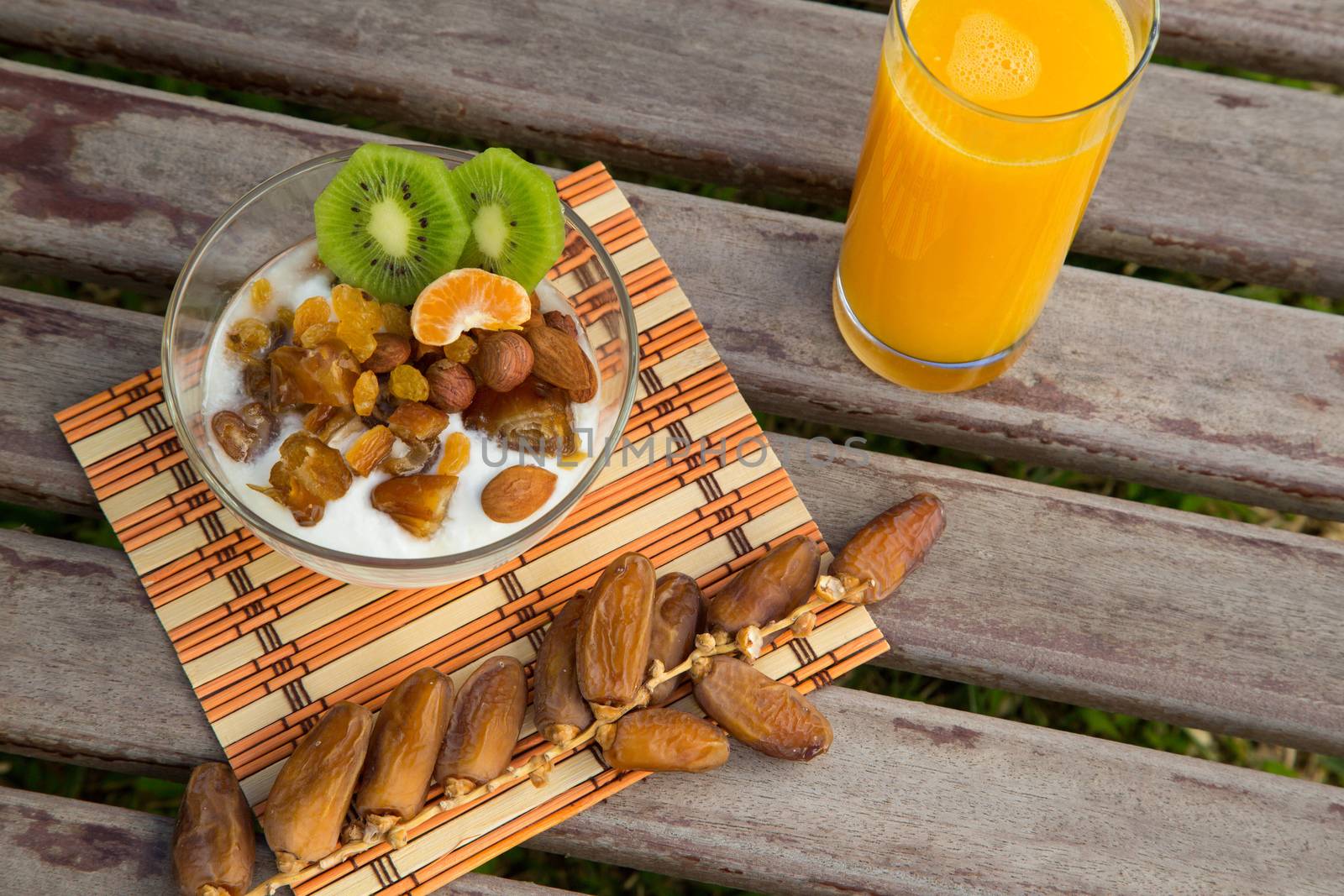 Healthy breakfast - natural yogurt with dried fruits and orange juice