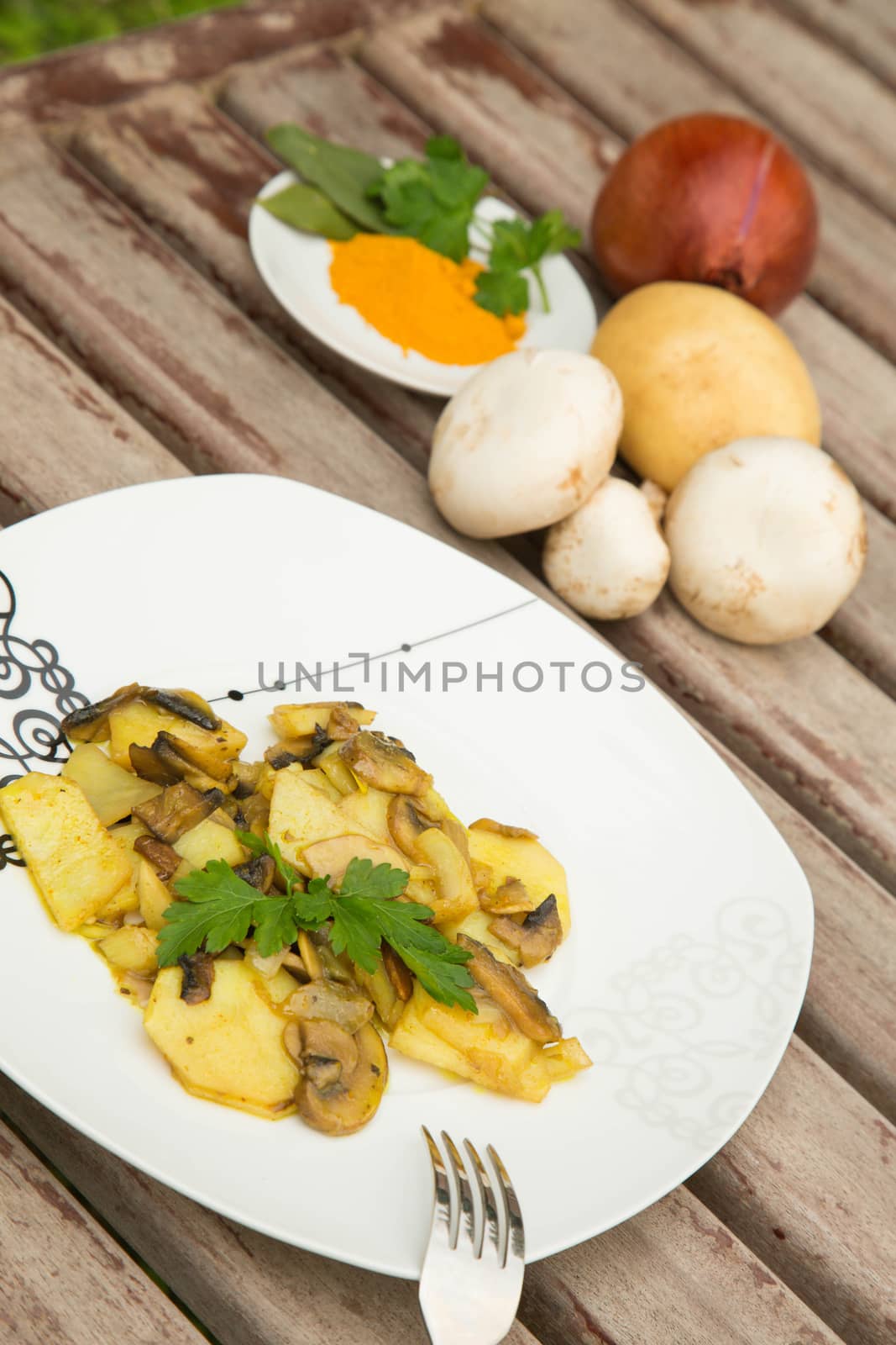 Baked potatoes with mushrooms and curcuma.Ingredients in the background