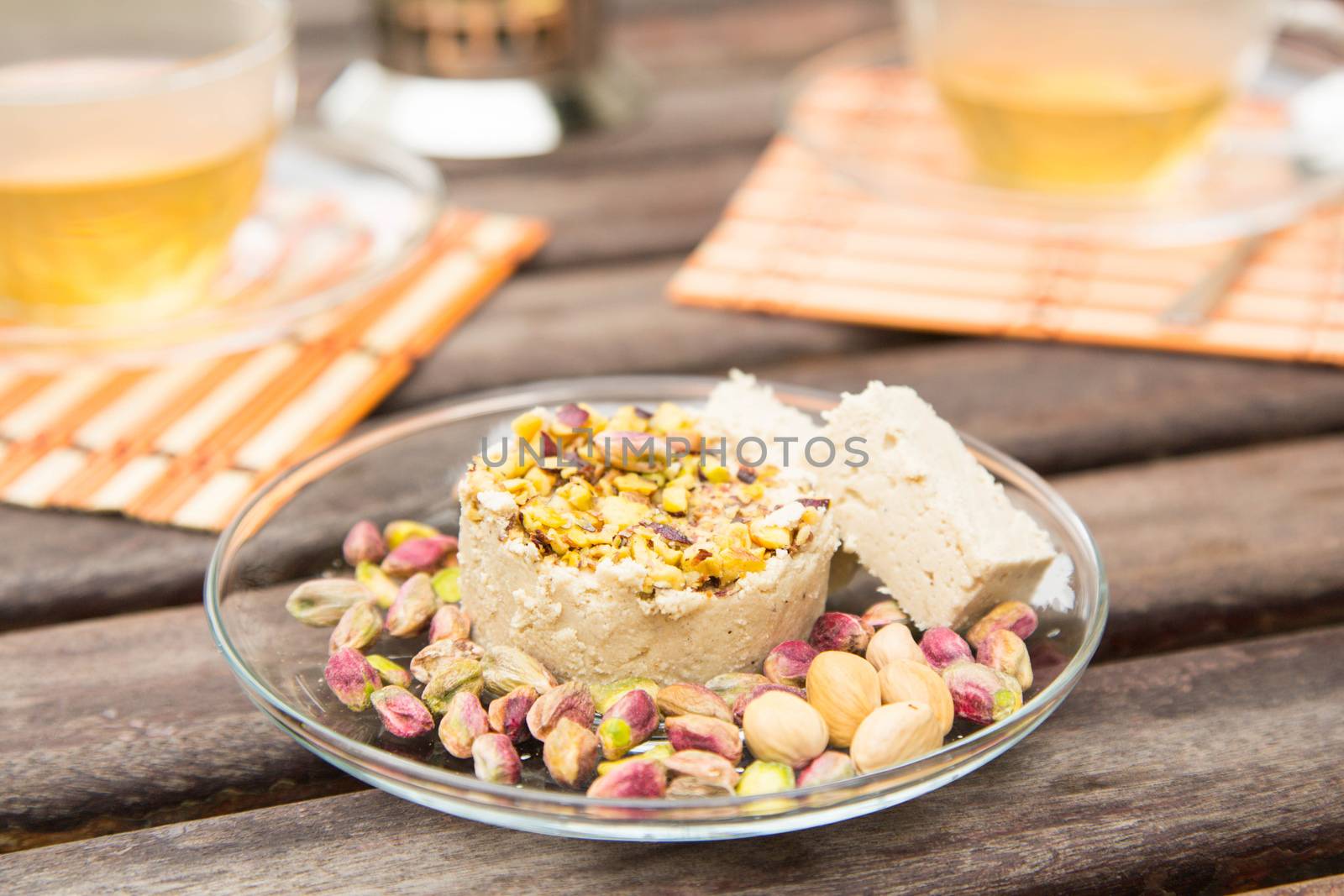 Halvah - paste of sesame with pistachios on the glass plate