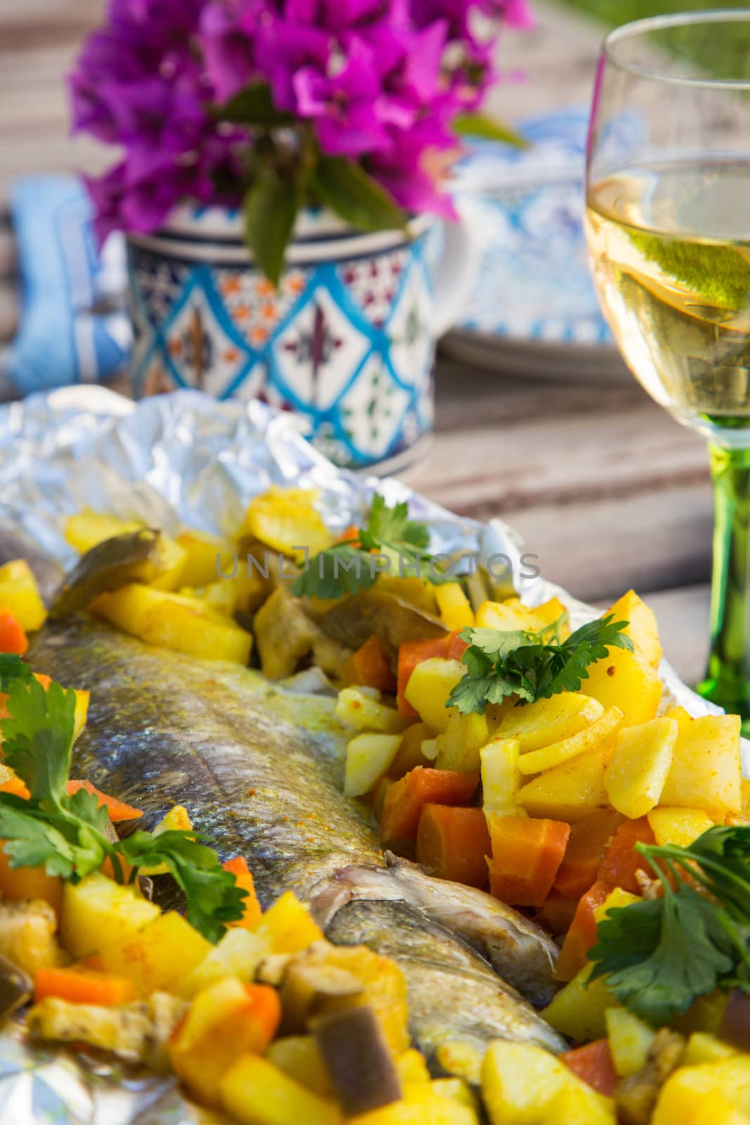 Baked sea bass with vegetables in the aluminum foil