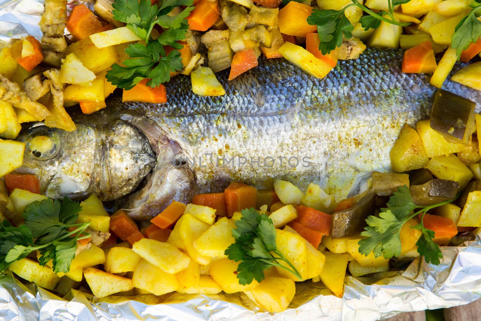 Baked sea bass with vegetables and curcuma by tolikoff_photography