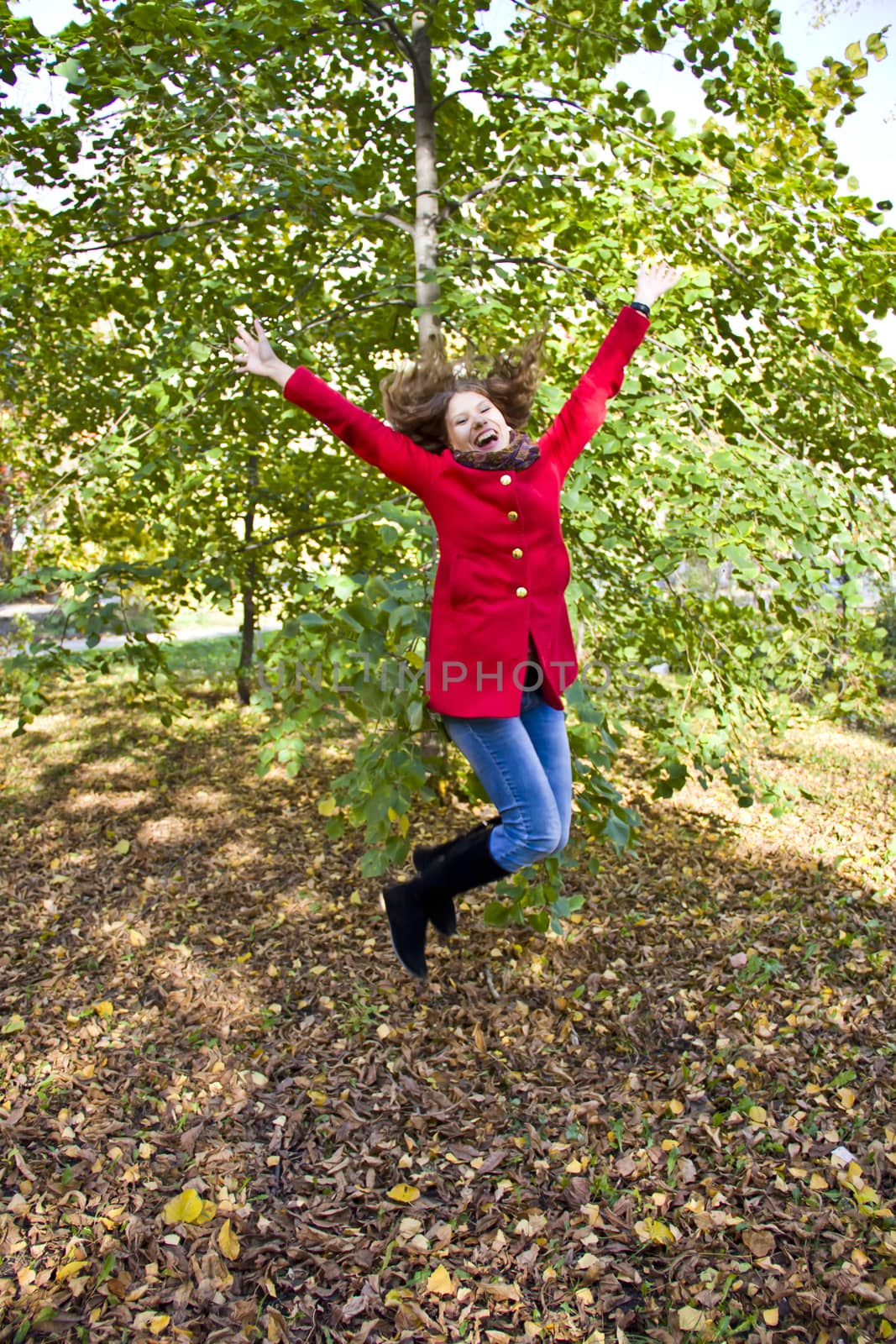 Photo of beautiful young woman with autumn leaves