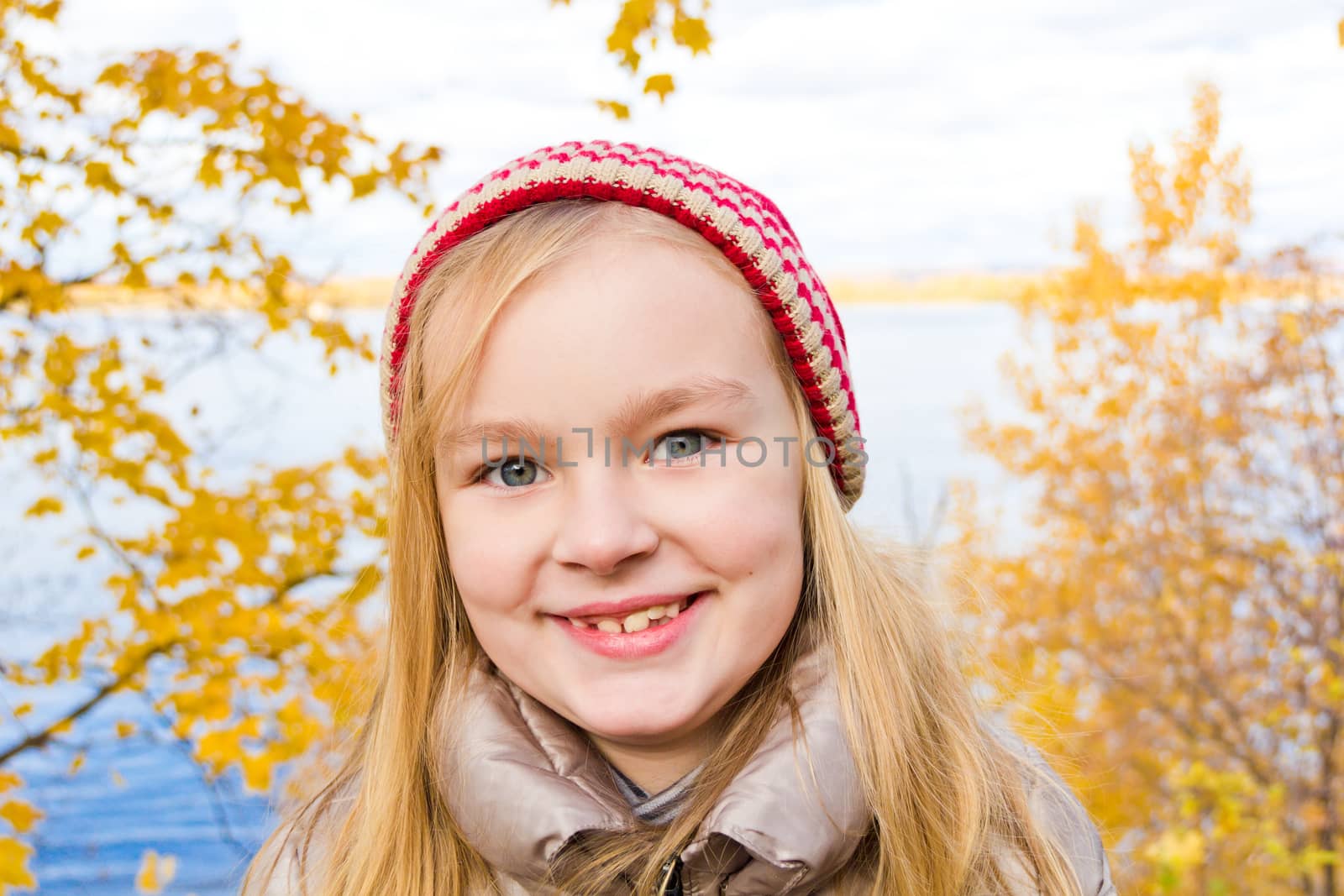 Photo of beautiful smiling girl in autumn