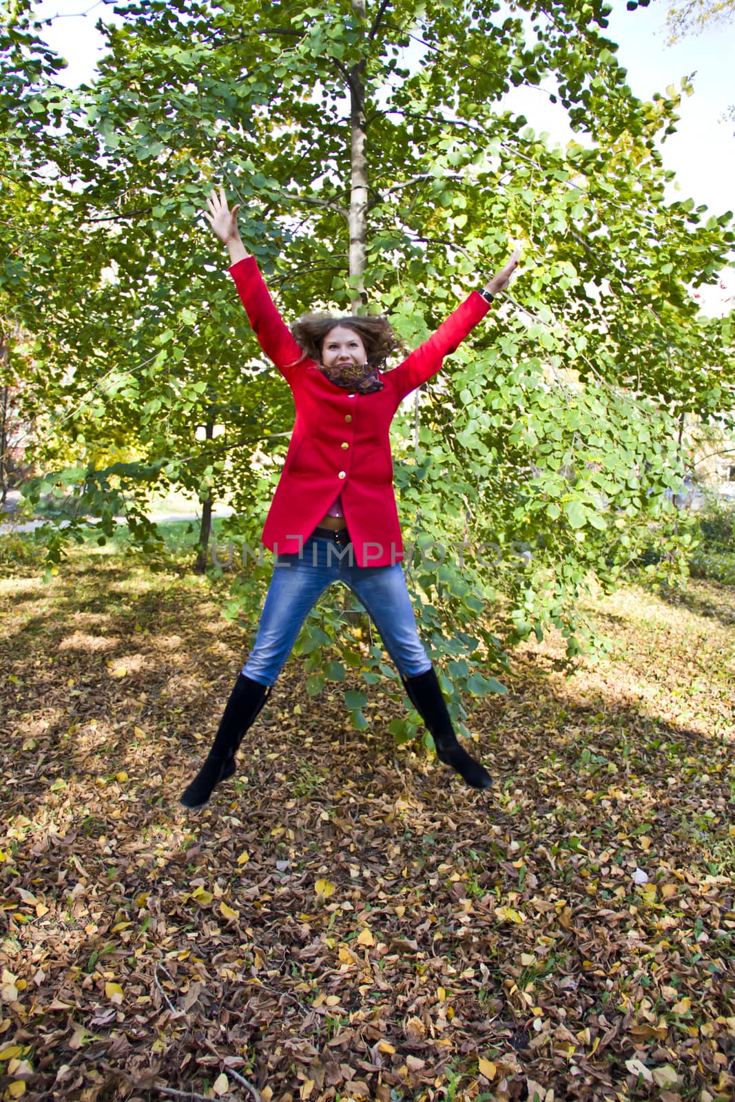 Photo of beautiful young woman with autumn leaves