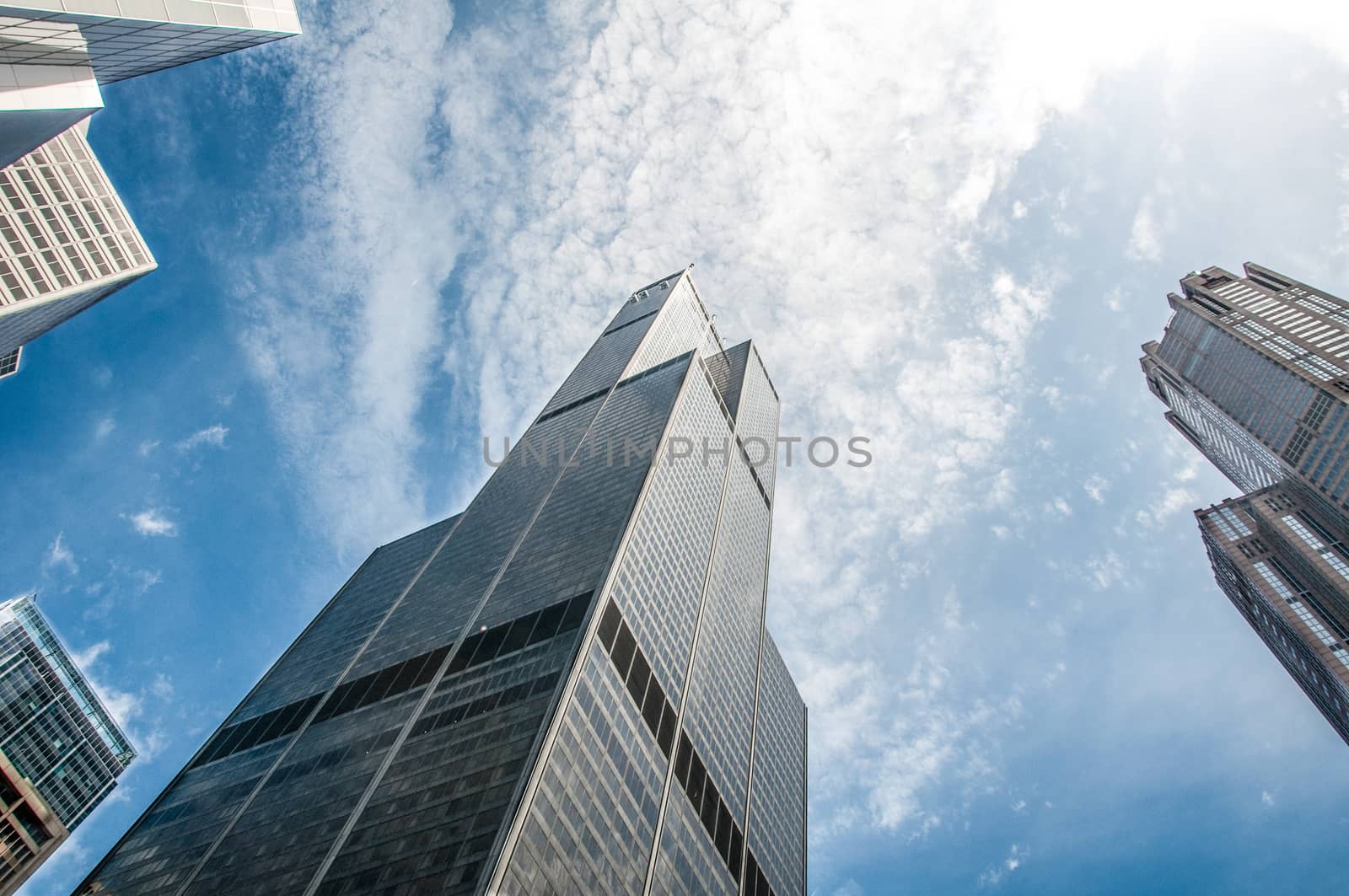Sears Willis tower under bright blue sky and cluds