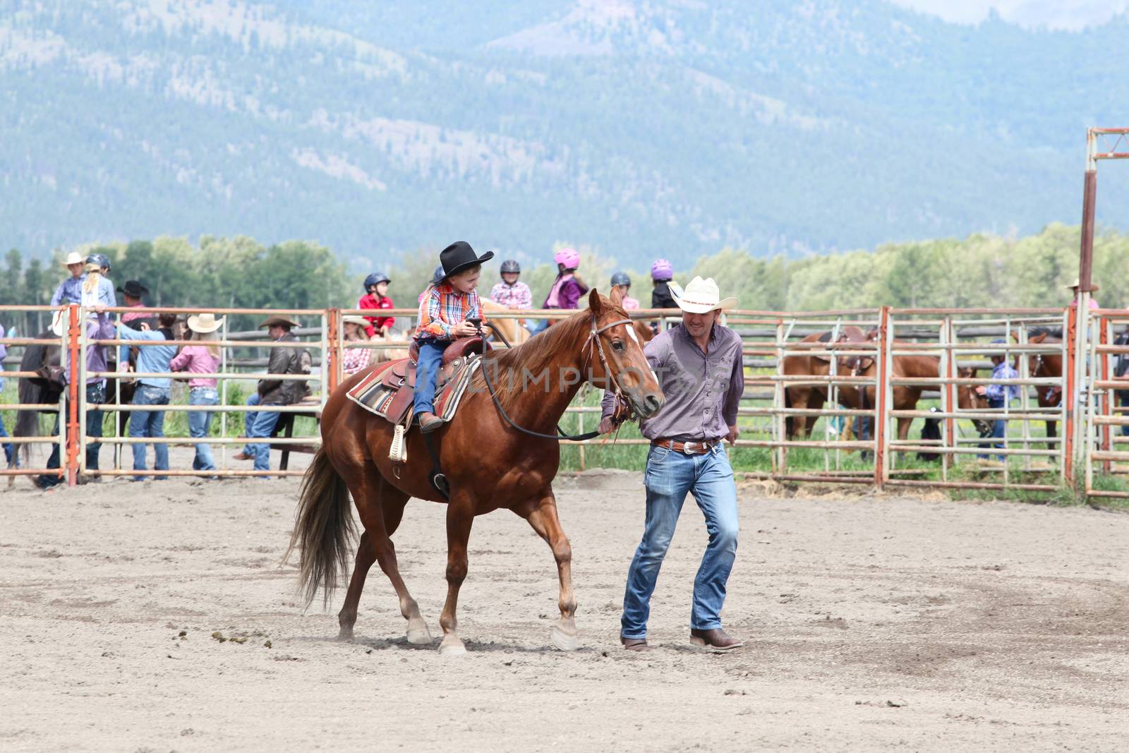 MERRITT, B.c. CANADA - June 14:  Young cowboy and his dad in stake race event at the Little Britches Rodeo June 14, 2014 in Merritt British Columbia, Canada