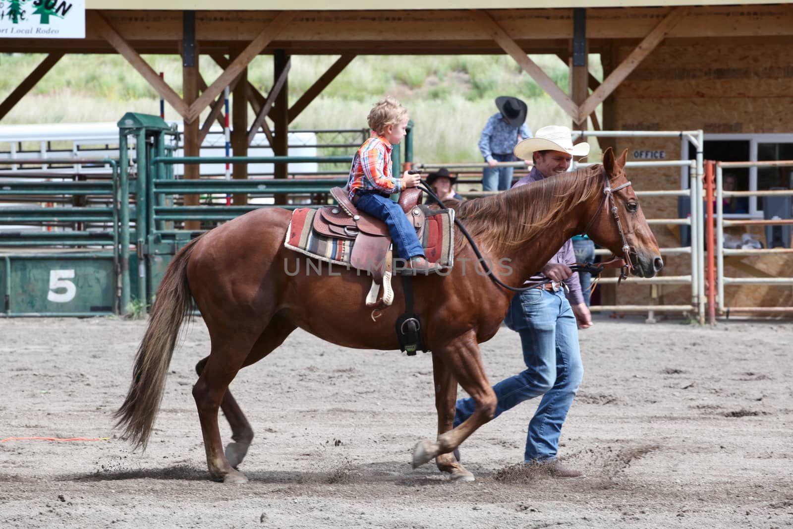 MERRITT, B.c. CANADA - June 14:  Young cowboy and his dad in stake race event at the Little Britches Rodeo June 14, 2014 in Merritt British Columbia, Canada