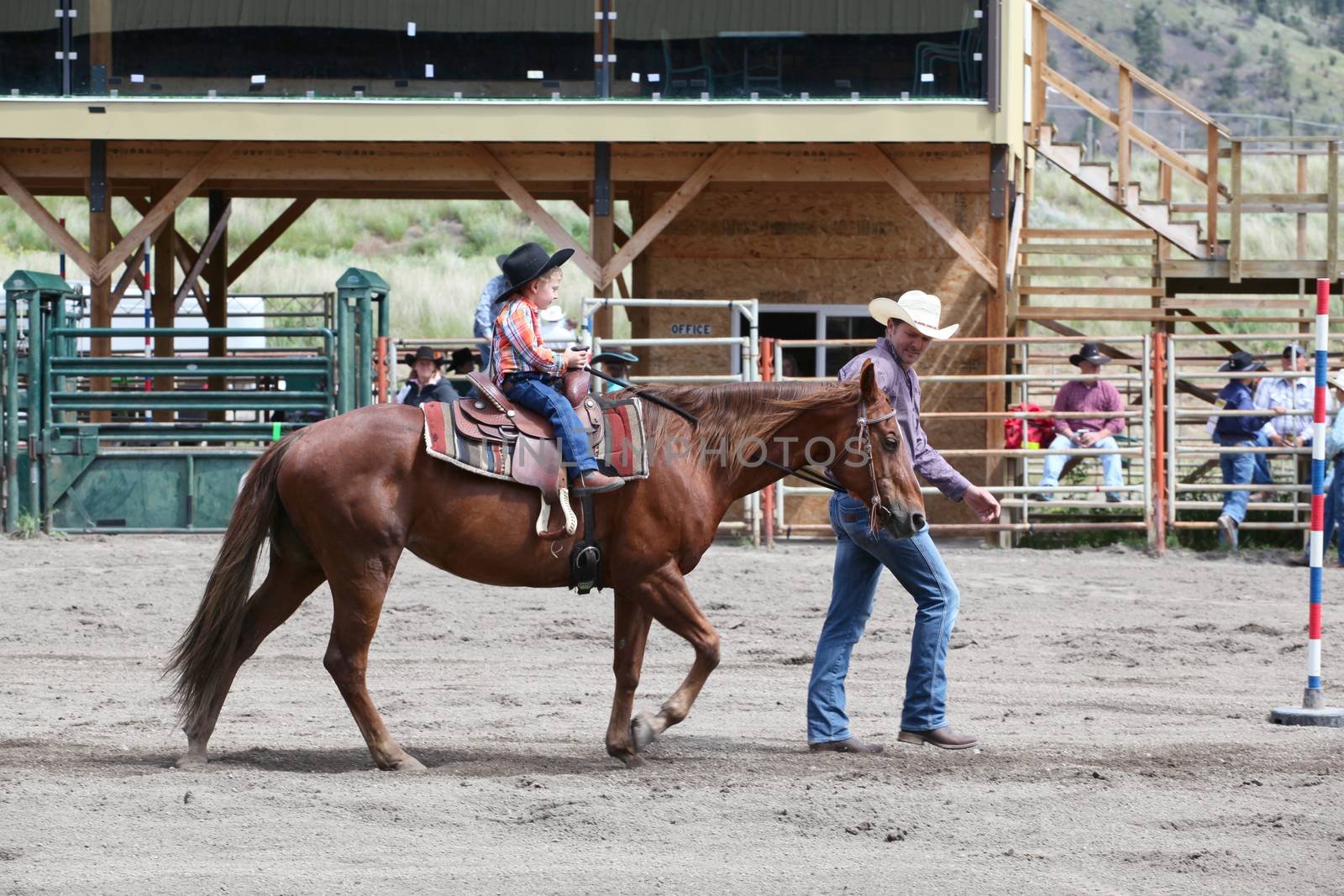 MERRITT, B.c. CANADA - June 14:  Young cowboy and his dad in stake race event at the Little Britches Rodeo June 14, 2014 in Merritt British Columbia, Canada