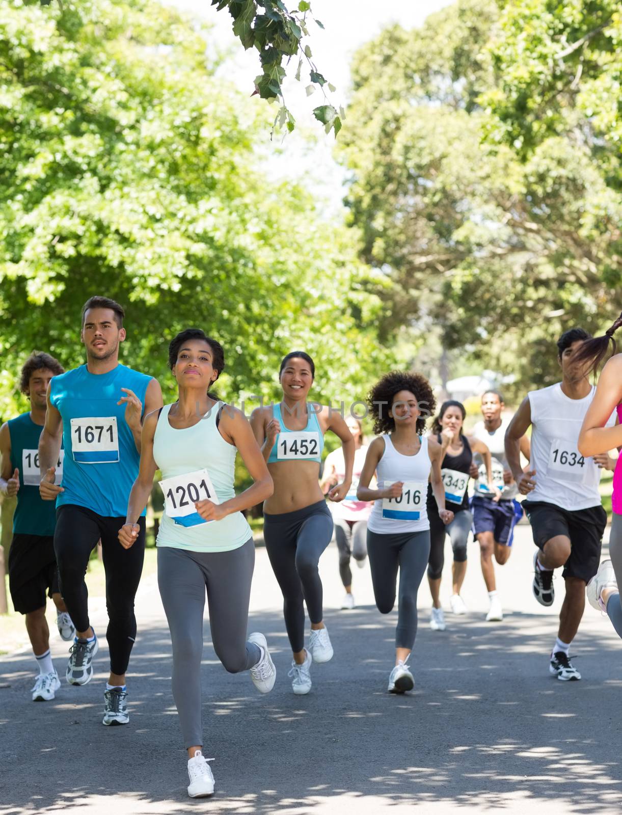 Group of marathon athletes running on street