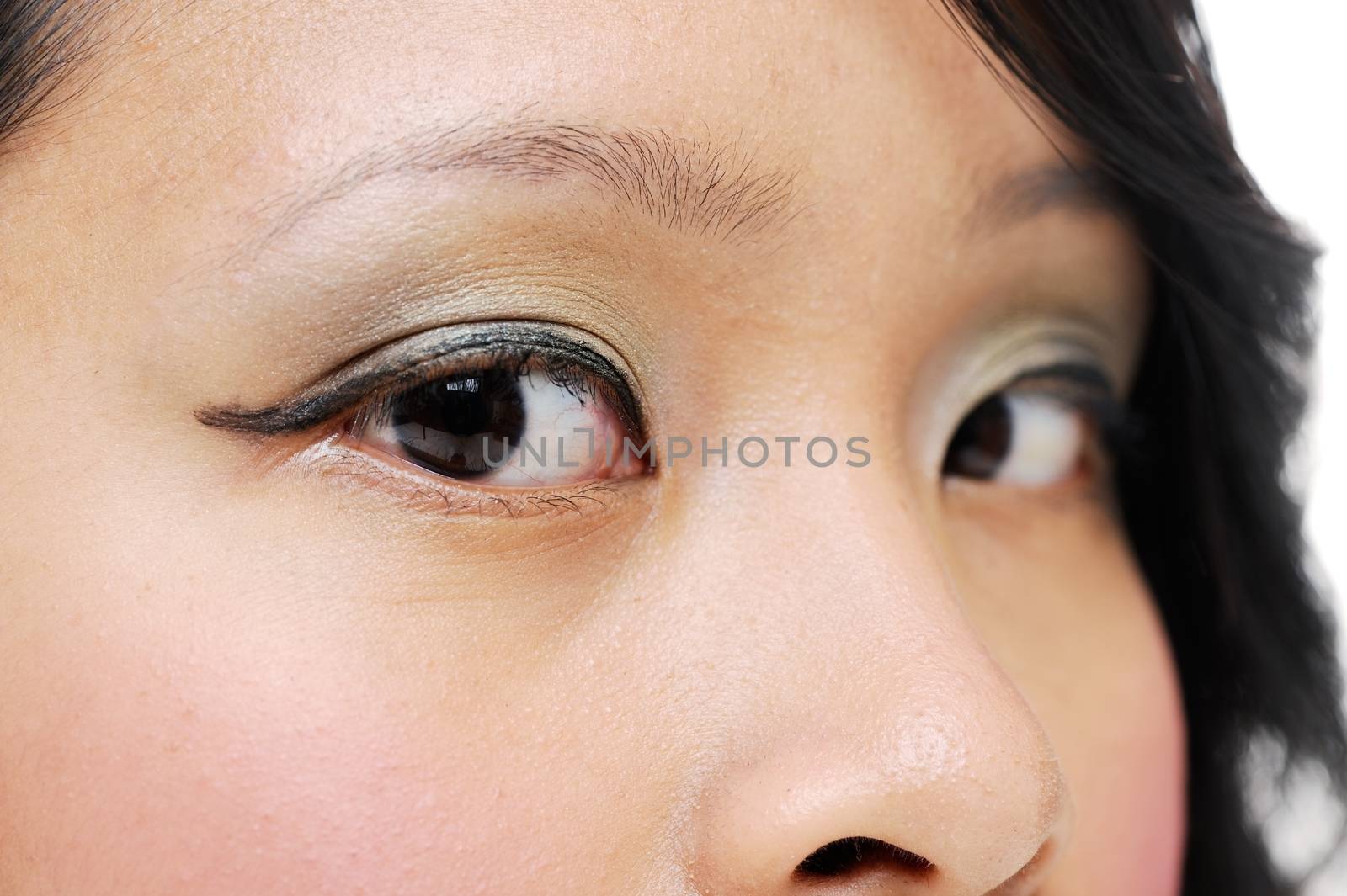 Asian girl wearing makeup closeup of brown eyes