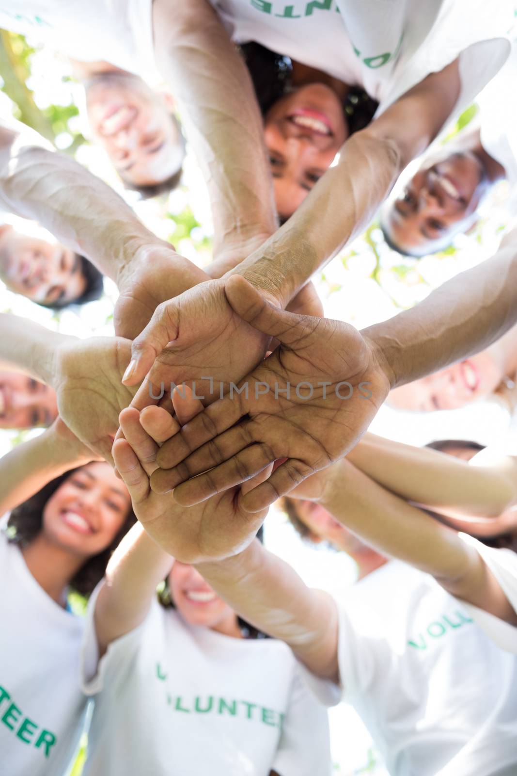 Group of environmentalists stacking hands by Wavebreakmedia
