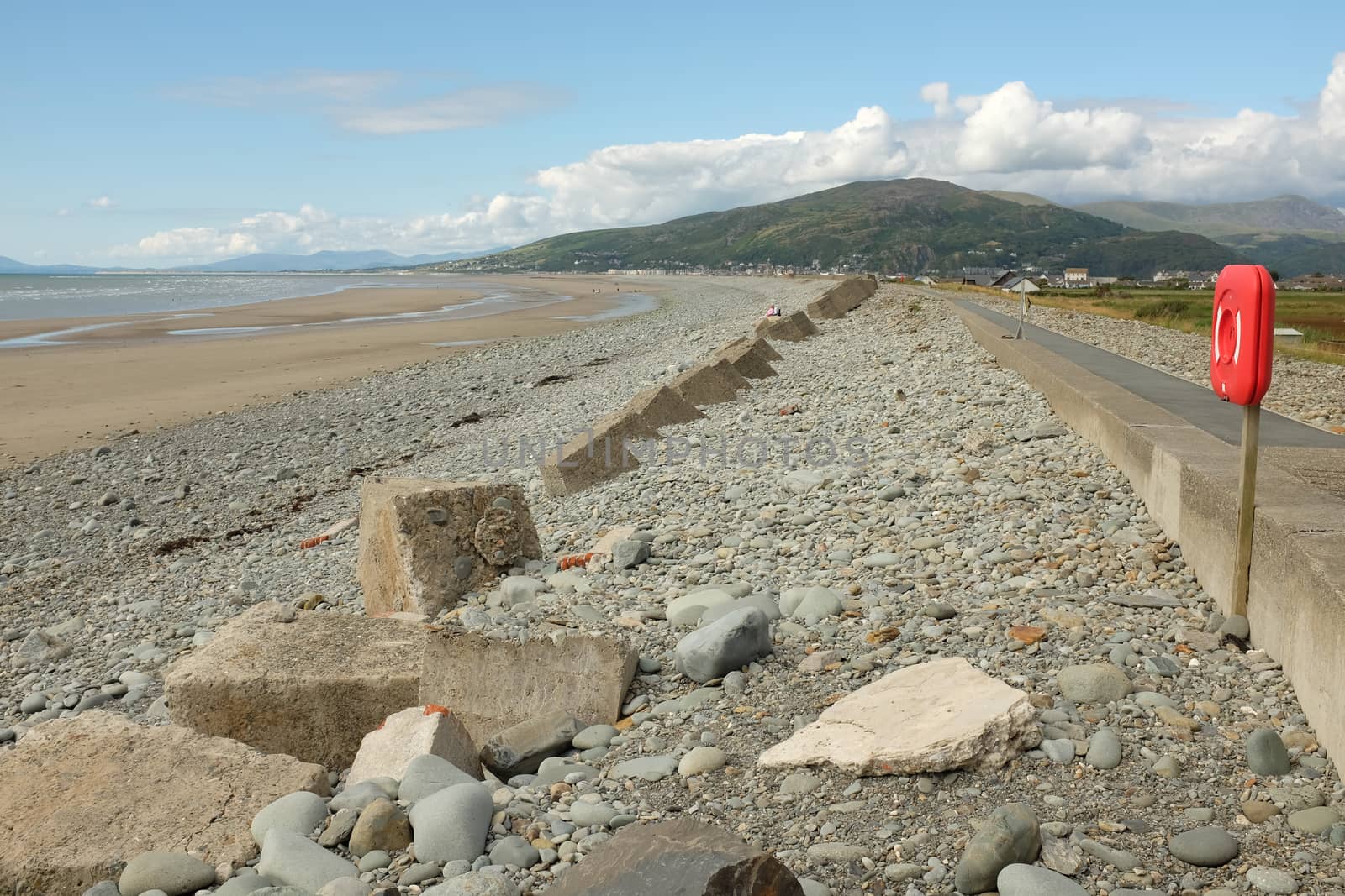 Pebbles and concrete  bollards make up the sea defences on the beautifull Fairbourne beach, Gwynedd, Wales, UK