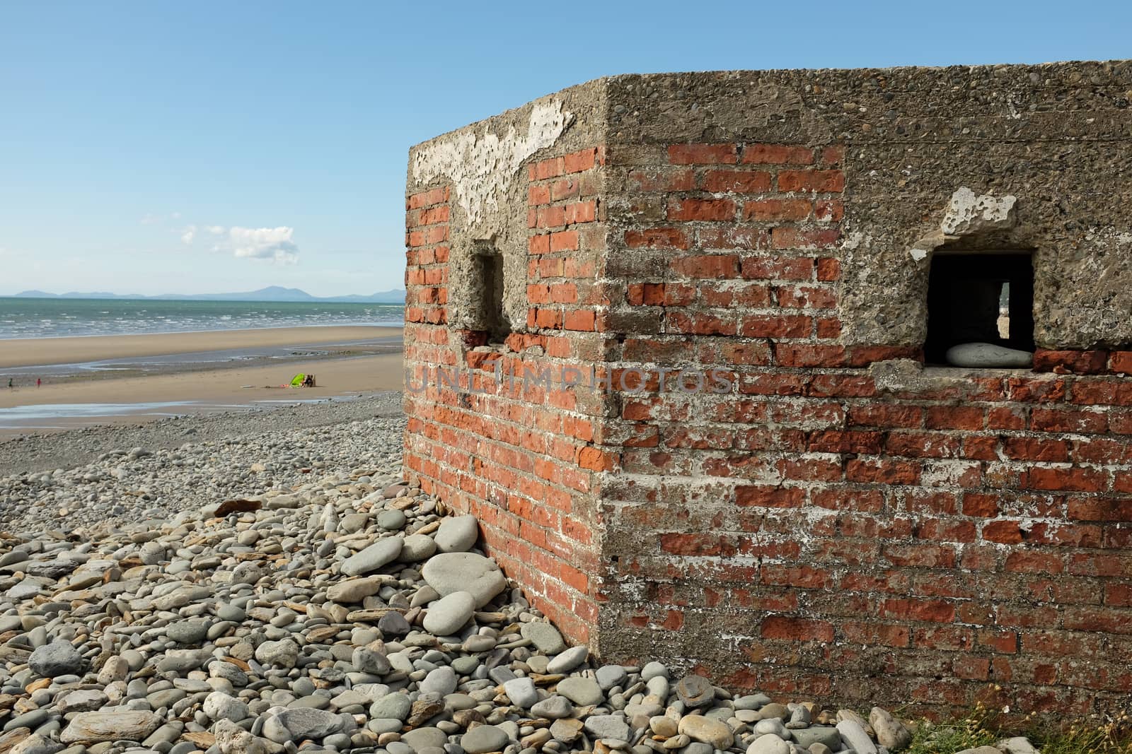 A red brick constructed defence bunker from the second world war looking out to sea.