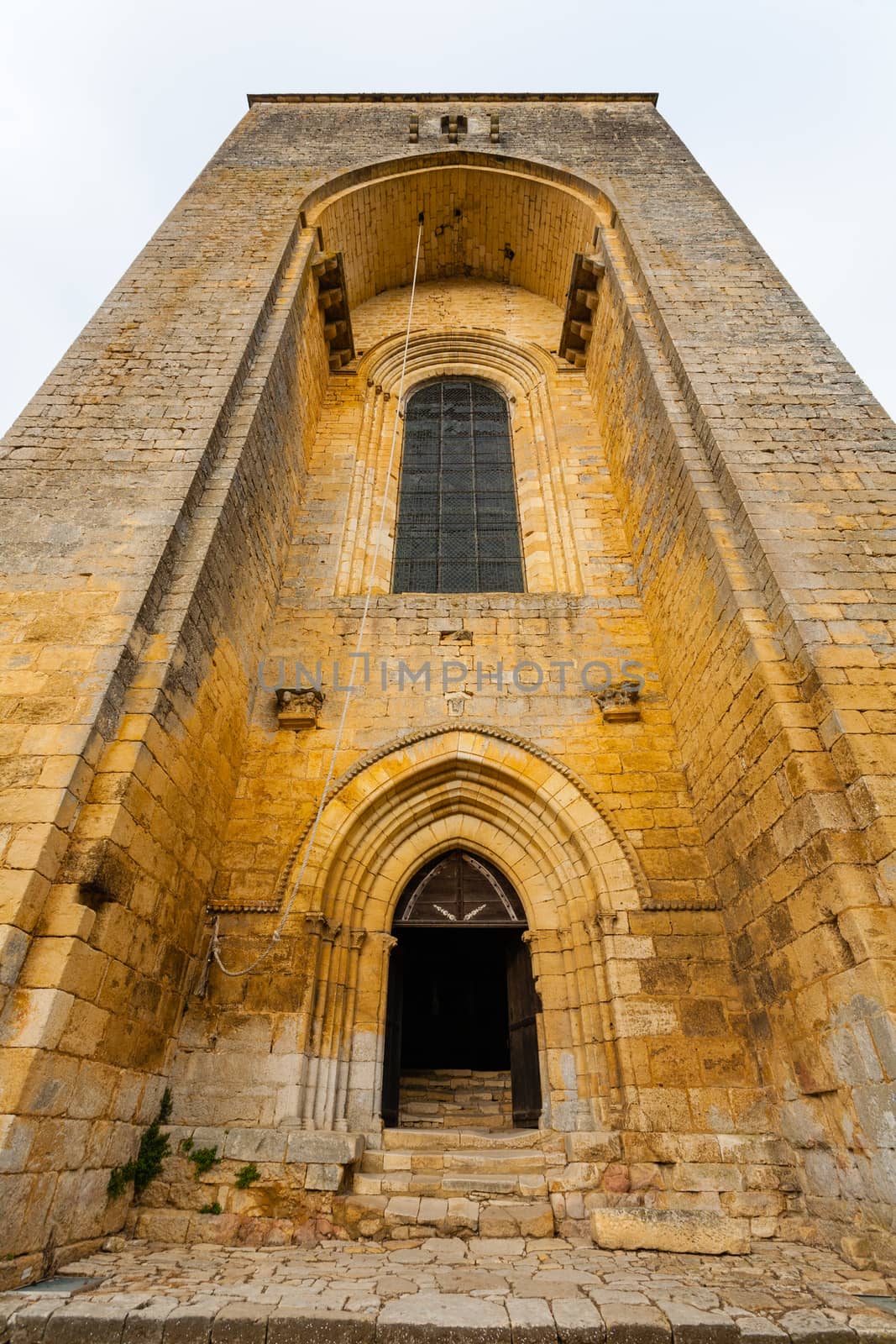 Impressive view of the main entrance  to the Romanesque fortified church of Saint Amand de Coly in the region of Dordogne, France