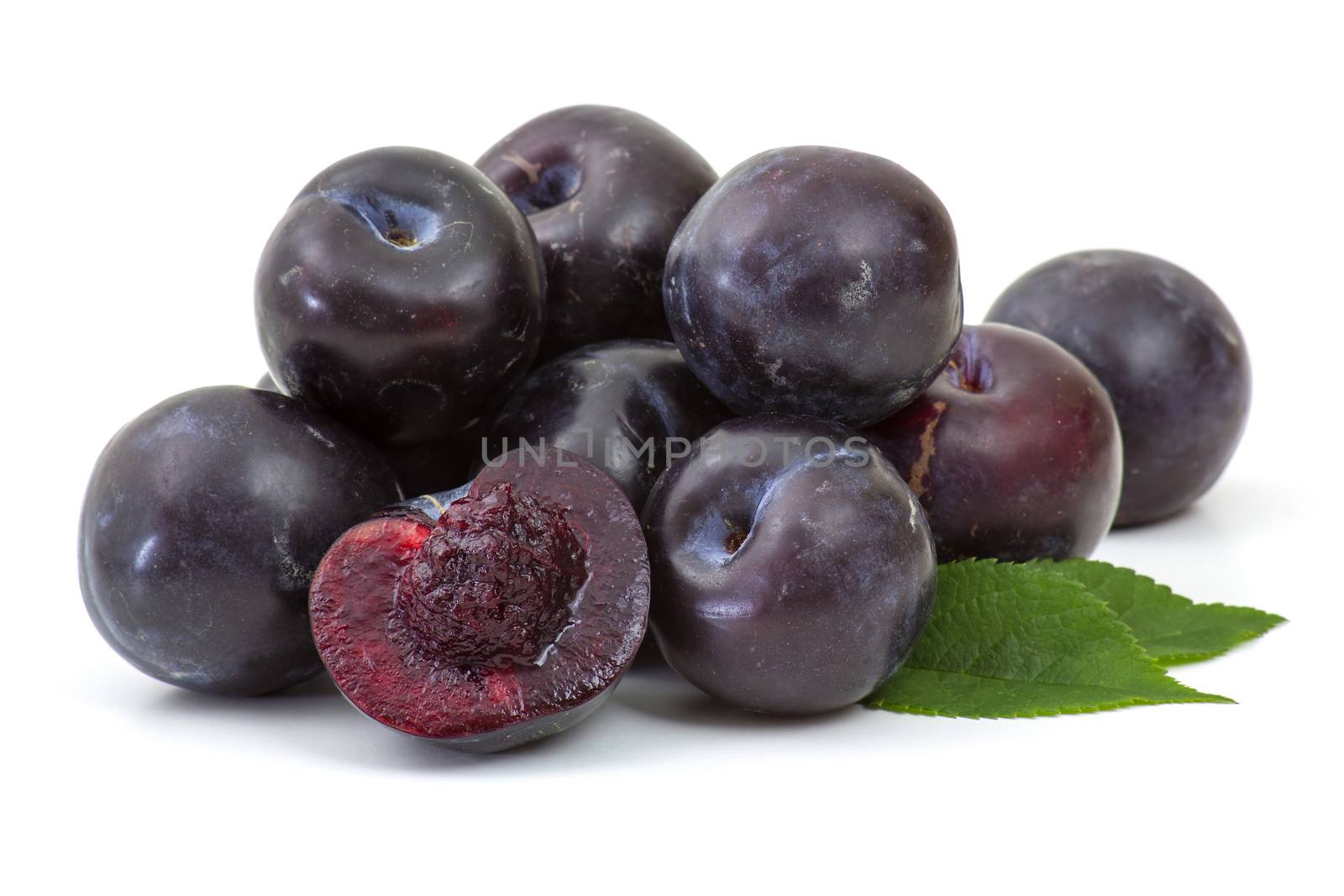 fresh plums on white background