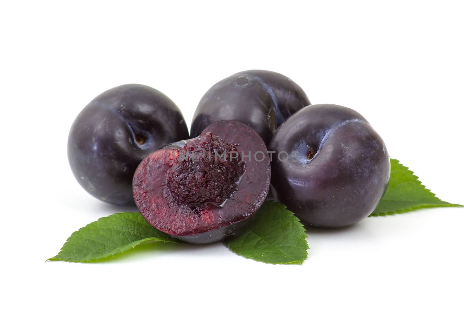 fresh plums on white background