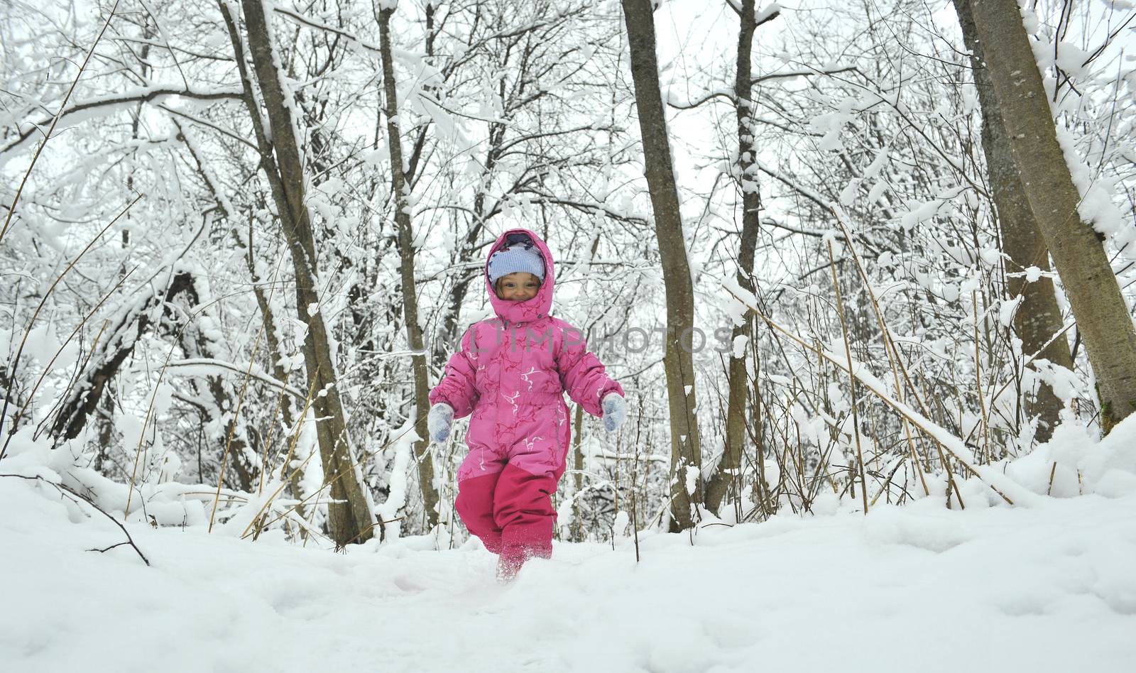 Little winter girl in fairy ice forest running  Little winter girl in fairy ice forest runing 