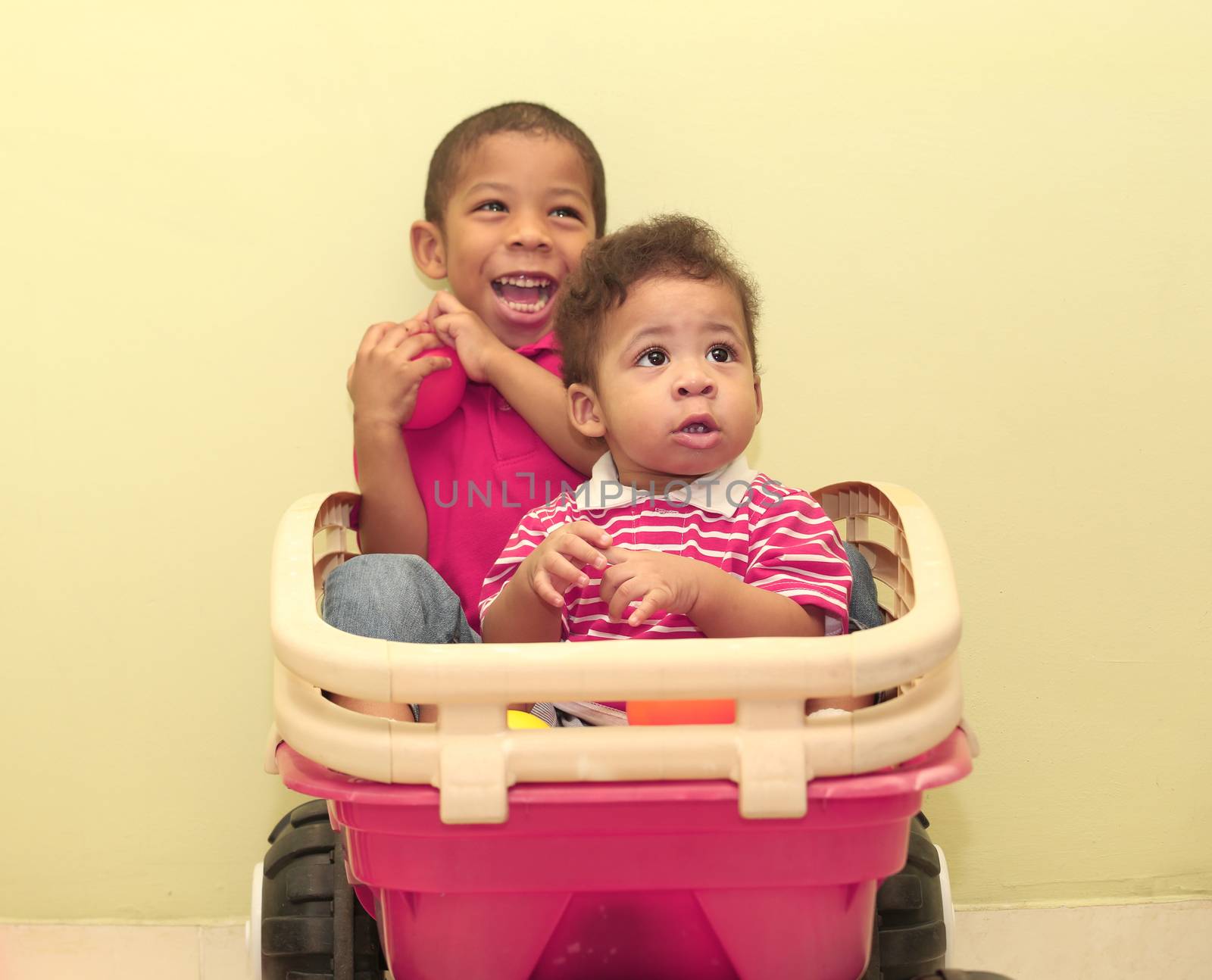 Portrait of two african boys inside a toy. Focus in the front boy.