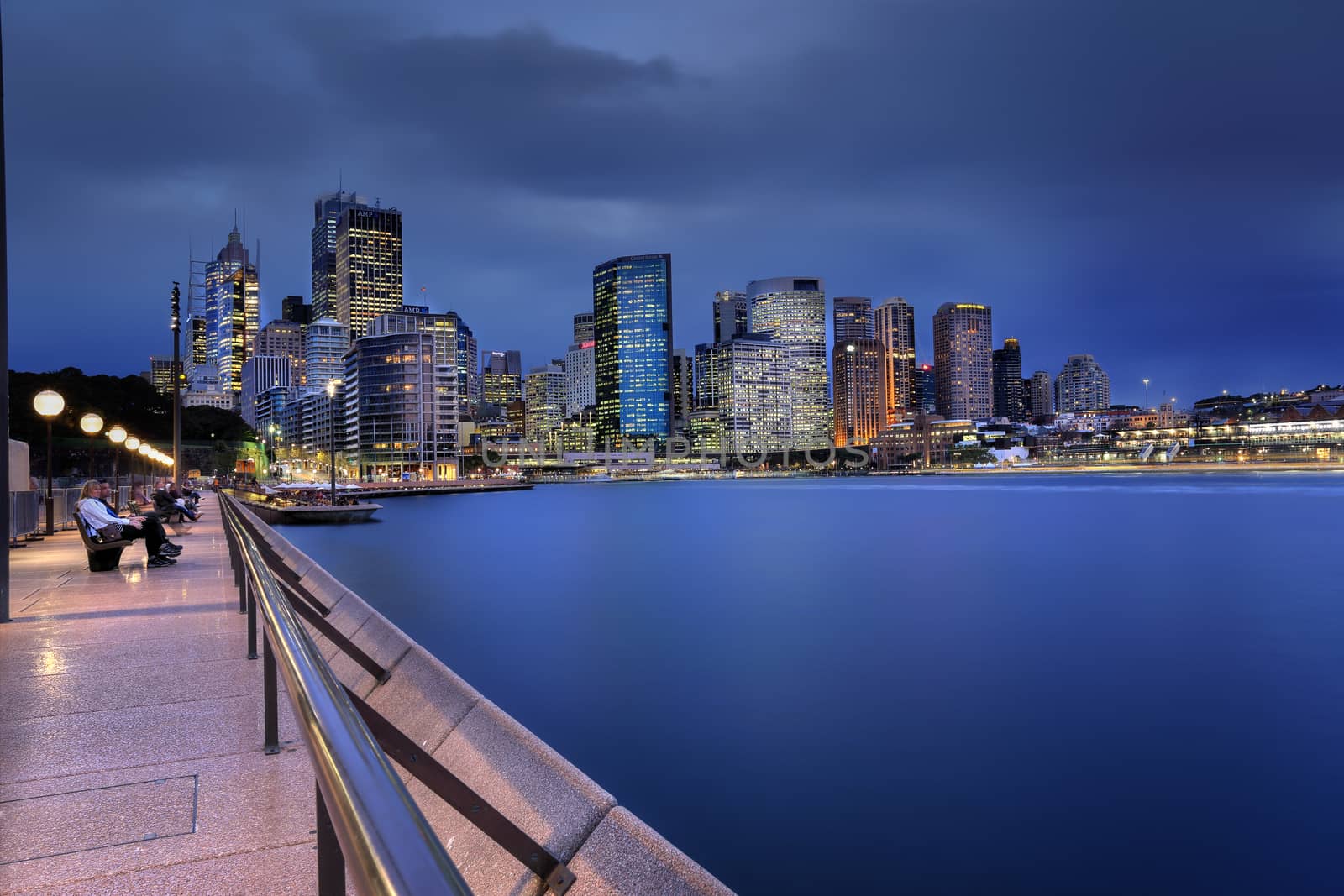 SYDNEY, AUSTRALIA - JULY 9, 2014; Circular Quay, Sydney at dusk as a storm blew in from the south west. Tourists relax on the foreshore.   Long Exposure  Australia