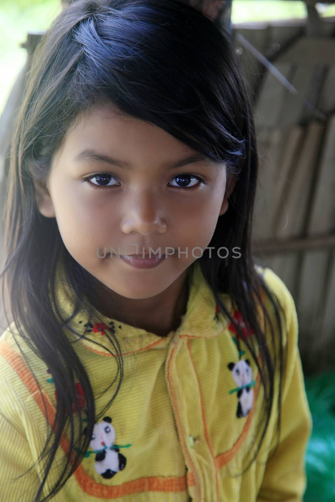 SIEM REAP, CAMBODIA - APRIL 06, 2014: Unknown cute and happy little Asian girl smiling at camera in Siem Reap 06 April 2014, Cambodia