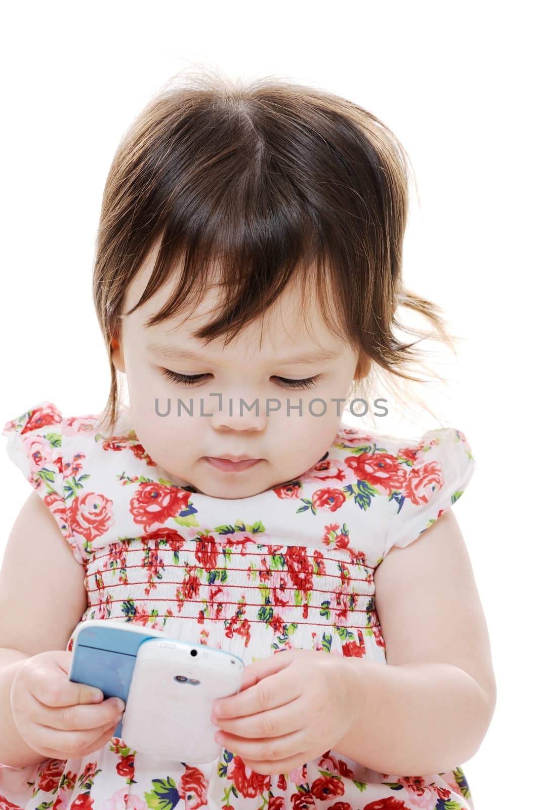 Young infant girl playing with mobile phone