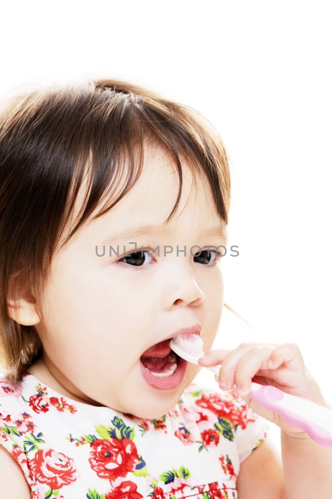 Little girl enjoys brushing her teeth