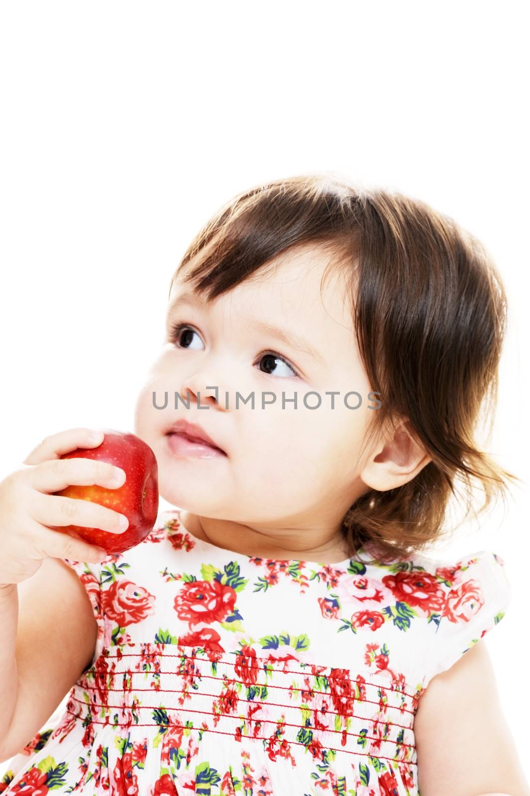 Little girl eating apple closeup portrait