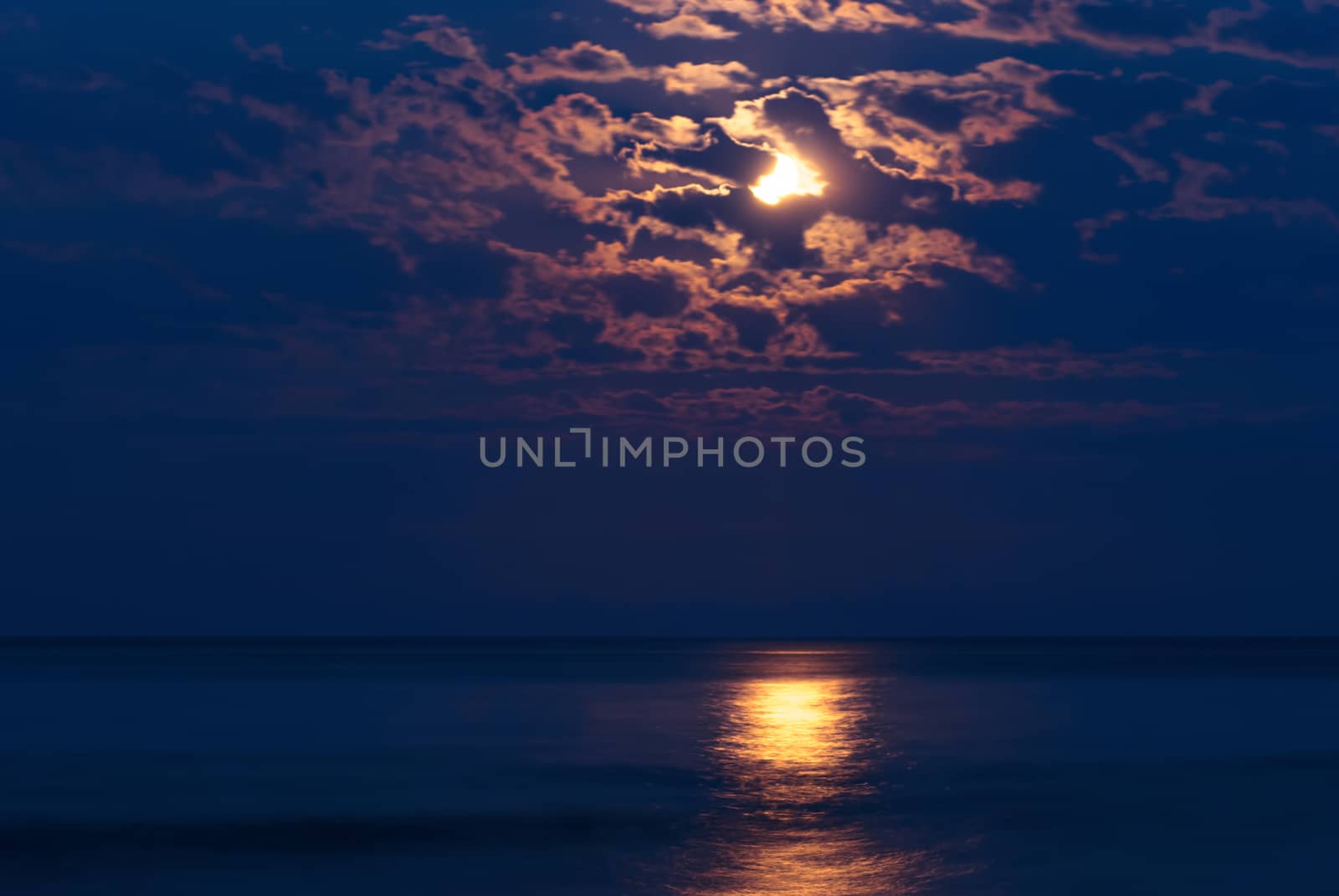 Full moon in night sky over moonlit water by Zhukow