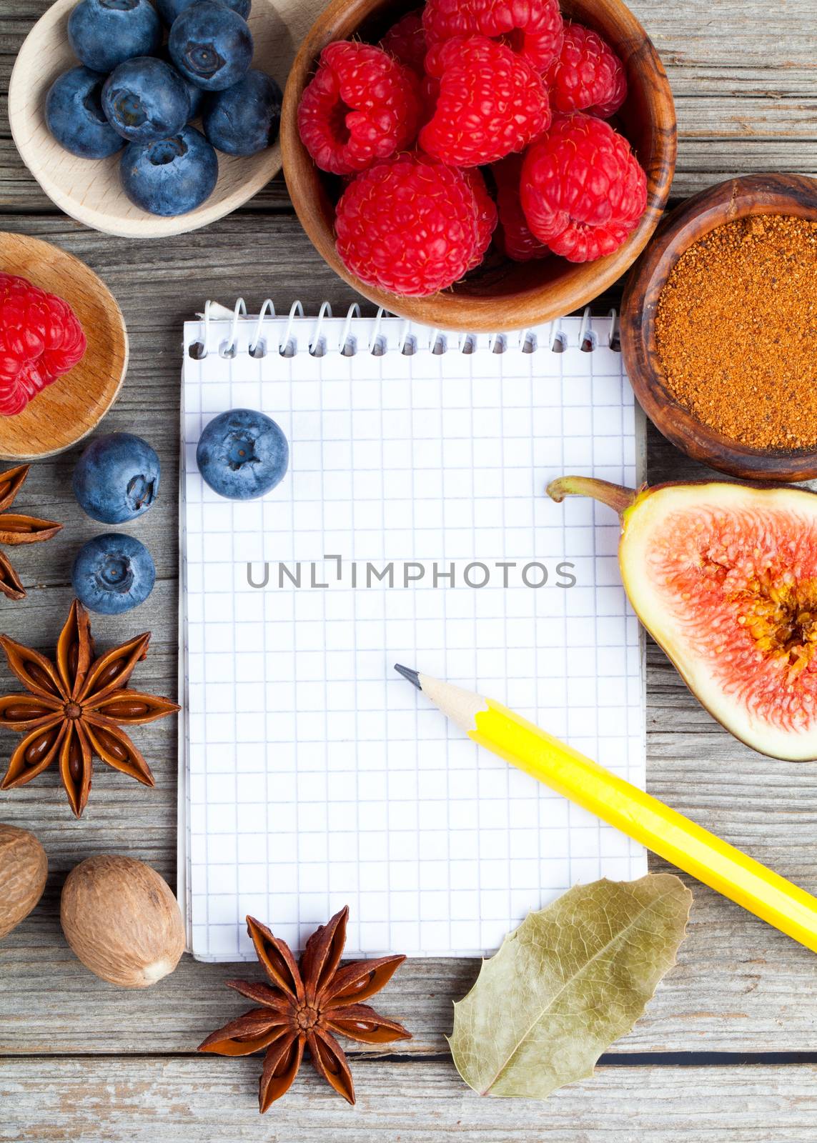 top view of recipe book with ingredients on wooden table by motorolka